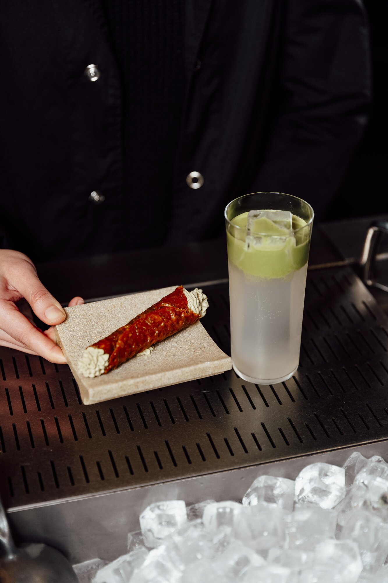 The Matcha Fizz cocktail from Auckland's Truth or Dare bar is served with a red bean and matcha-filled brandy snap, part of a series of cocktails that pair with canapes. Photo / PM Creatives