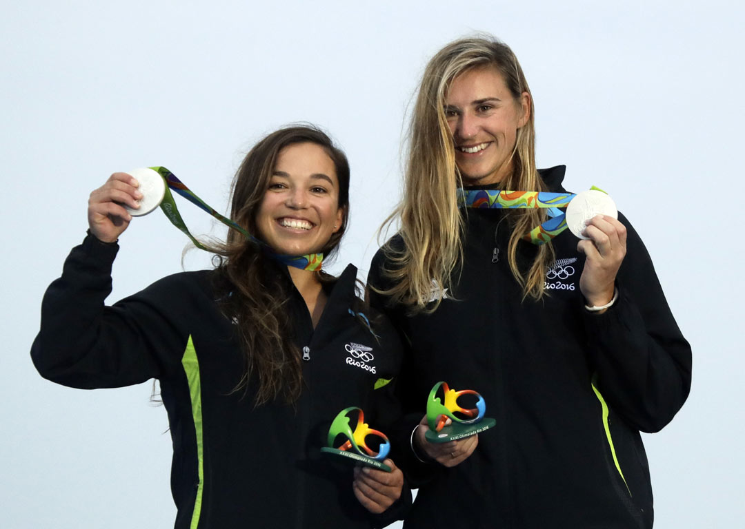New Zealand's Alex Maloney and Molly Meech celebrate on the podium at the end of the 49er FX women race. Photo / AP