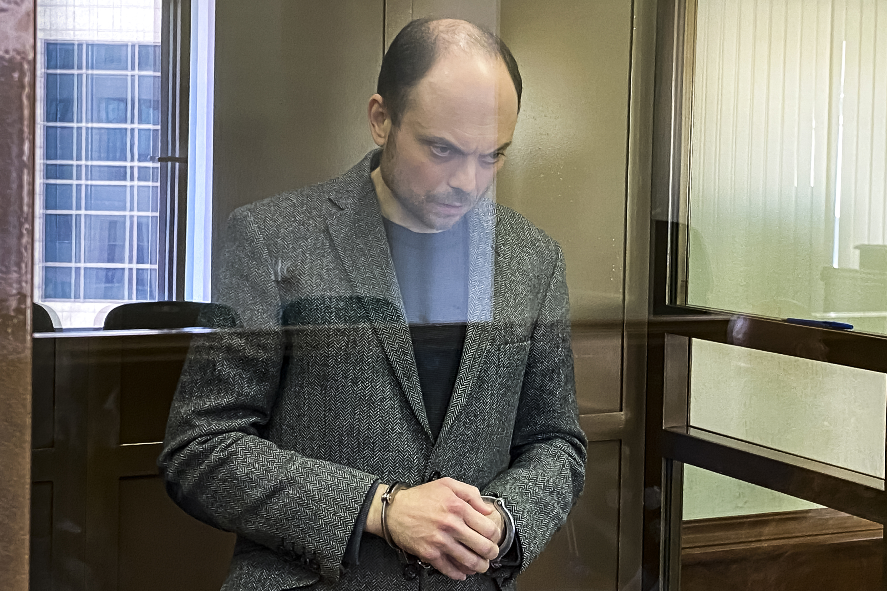 Vladimir Kara-Murza awaits sentencing in a glass cage in the Moscow City Court. Photo / AP