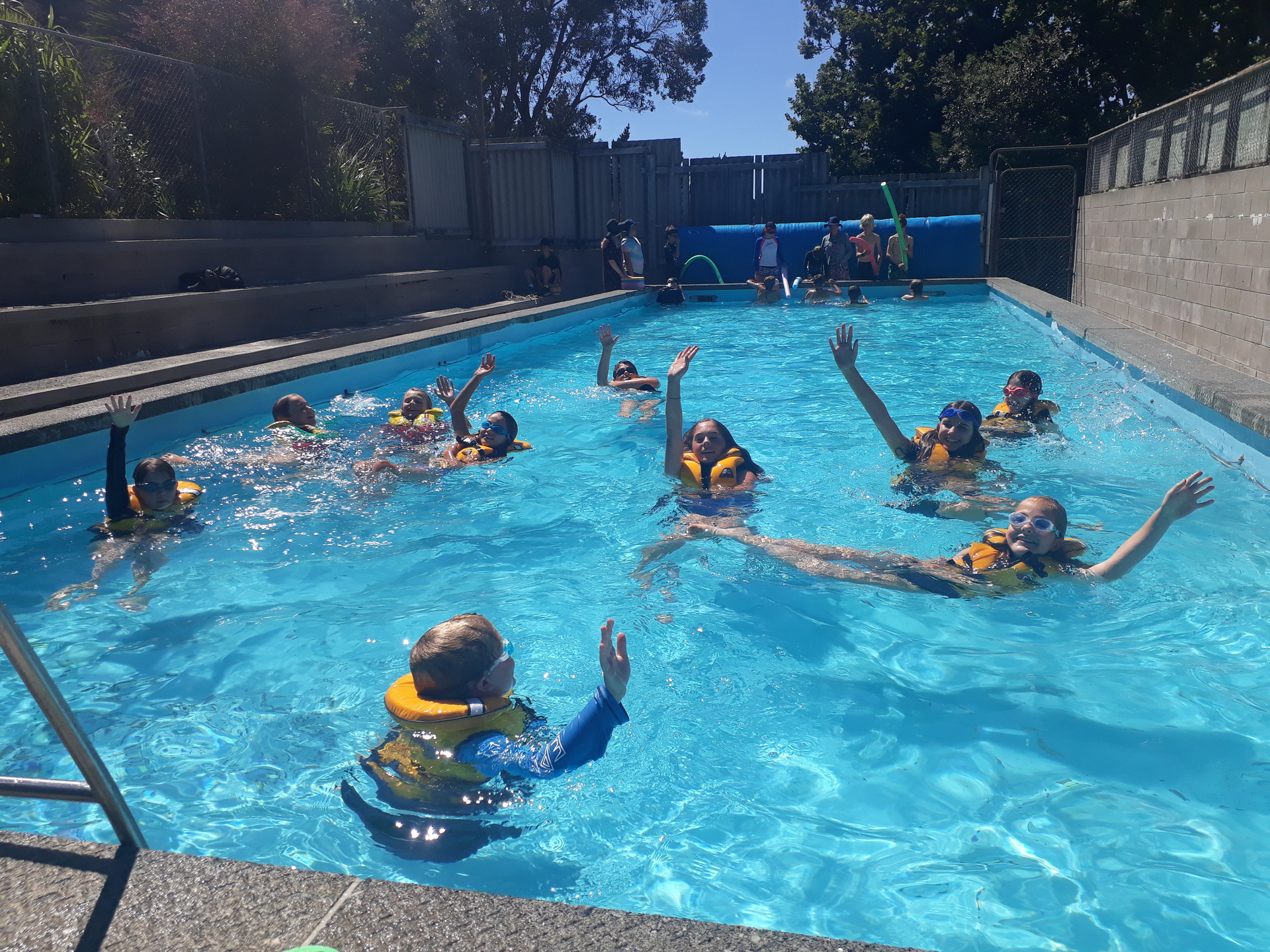 Whangārei Heads School students practising floating with an arm raised in a lifejacket as part of the WaterSafe Programme. Photo / Supplied

 