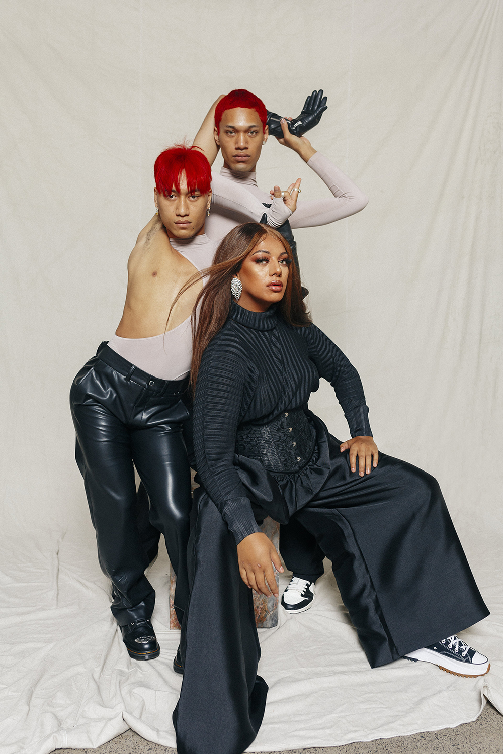 From left: Ethan Hika wears Entire Studios bodysuit, Stolen Girlfriends Club gloves and trousers. Jojo Tapasu wears Stolen Girlfriends Club gloves. Jaycee Tanuvasa wears Pleats Please top by Issey Miyake from Scotties, Harris Tapper trousers, Superette earrings and own corset and shoes. Photo / Hohua Ropate Kurene