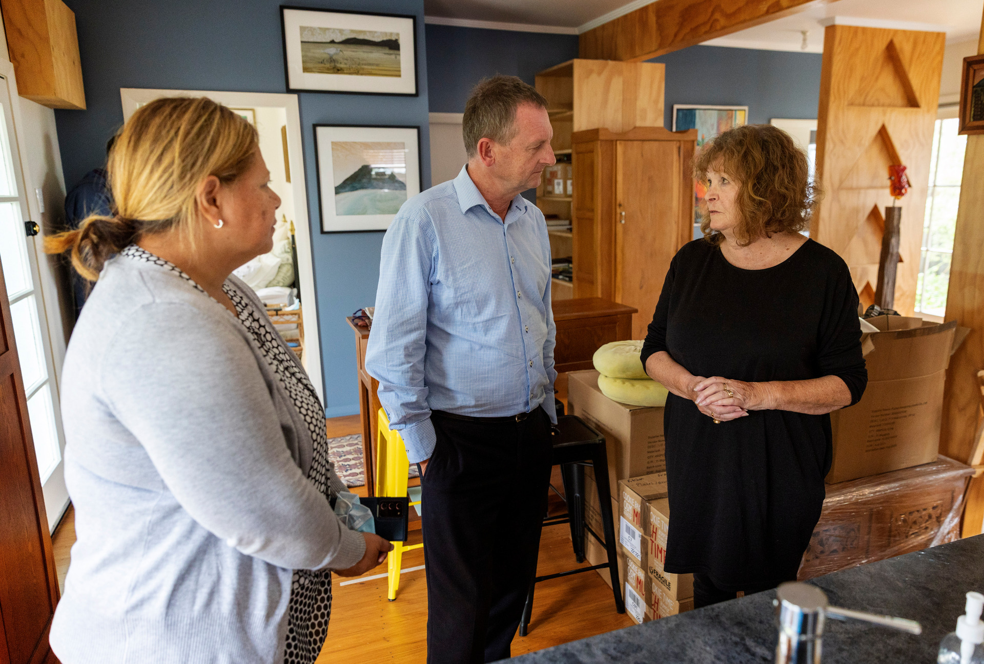 Maggie Wilkinson, right, speaks to Auckland Anglican Bishop Ross Bay and Judy Matai'a, chief executive of the Anglican Trust for Women and Children, after the apology meeting. Photo / Mike Scott