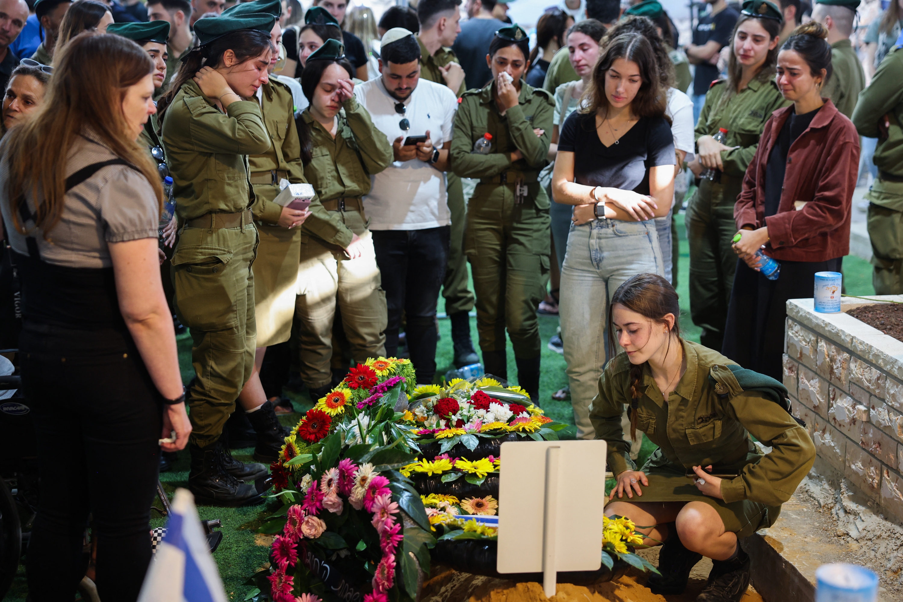 Relatives and friends mourn by the grave of Israeli soldier Eitan Itzhak Oster killed in fighting in the northern border area with Lebanon, during his funeral at the Mount Herzl Military Cemetery in Jerusalem on October 2, 2024. Photo / AFP)