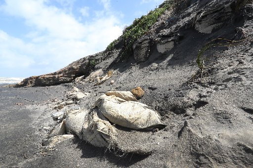 An image taken in 2019 of the sandbags that litter the cliff at Baylys Beach. Photo / John Stone