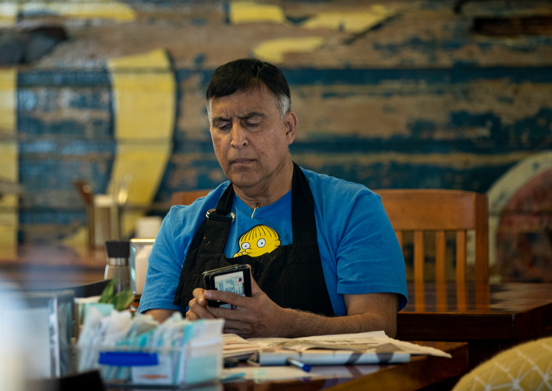 Dilip Rupa, pictured at his cafe today, did not appear in court for refusing to display a Covid-19 QR code. Photo / Dean Purcell