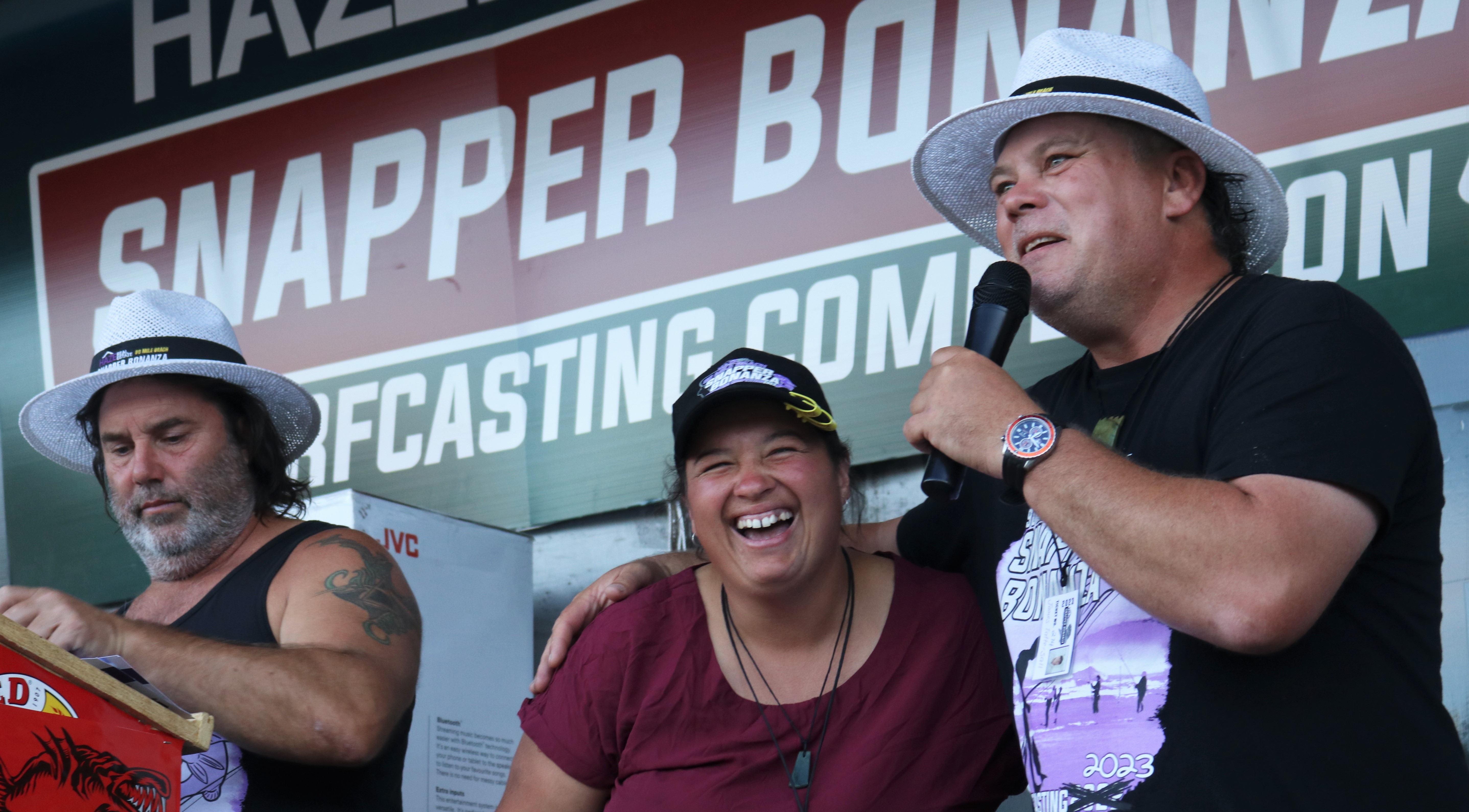 Gillian Fisher, of Kaitāia, finds out from MC James Tattersall that she’s won $2000 for the ladies’ average fish. Photo / Peter de Graaf
