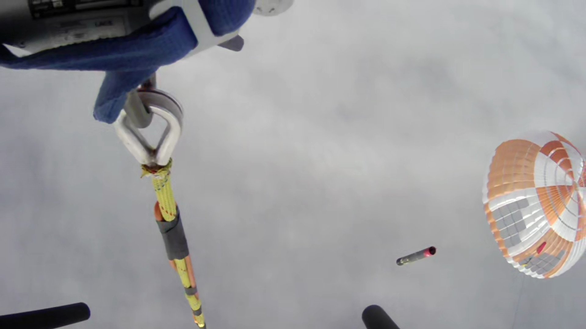The view from the twin-engined Sikorsky S-92 helicopter moments before it hooked the parachute line of the booster falling to Earth at 10m per second. Image / Rocket Lab livestream

