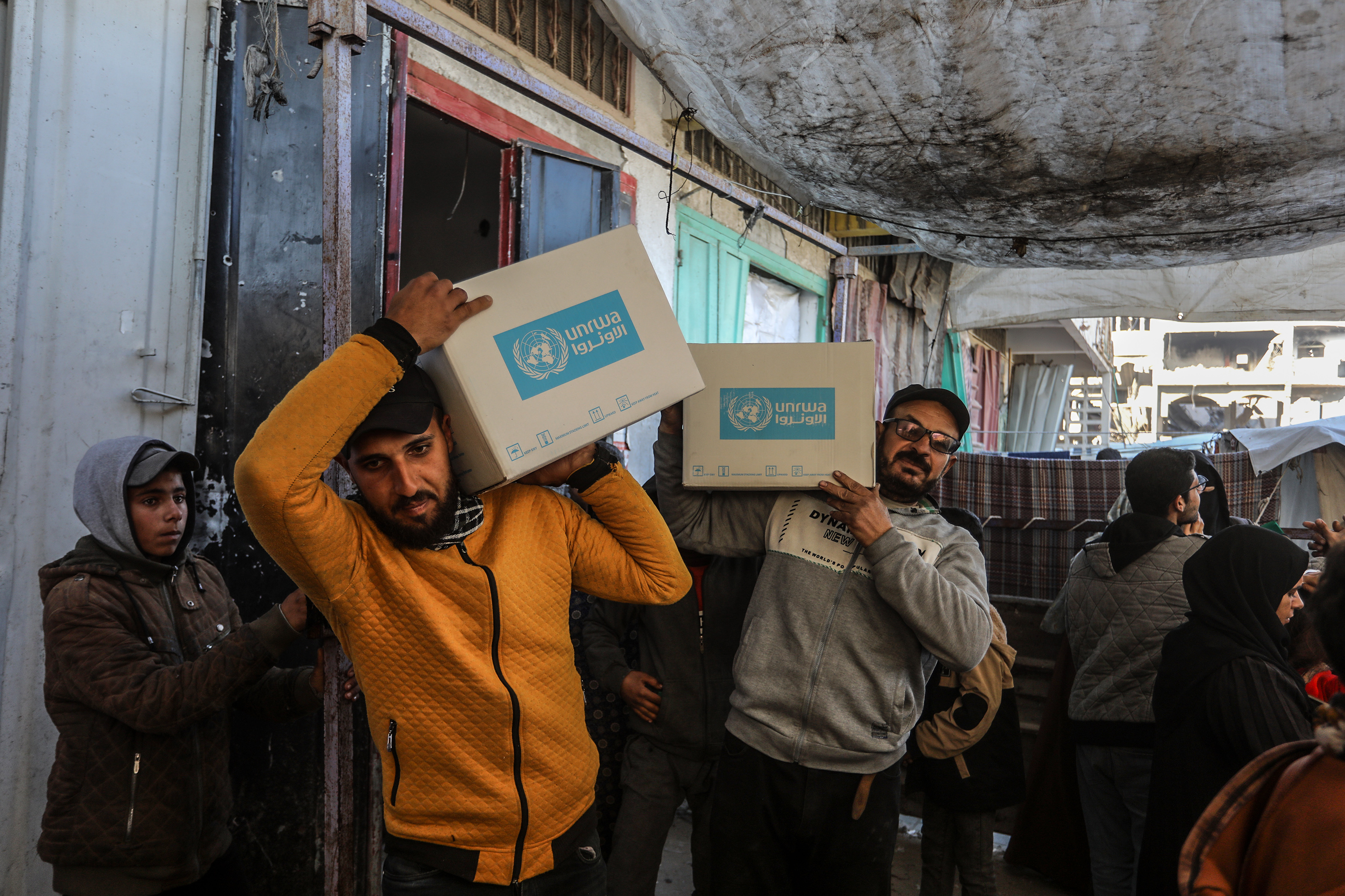 Displaced Palestinians receive emergency food parcels for families from the UNRWA centre in Khan Younis, after aid trucks entered through the Karem Abu Salem crossing in Rafah city, amid a ceasefire deal between Israel and Hamas. Photo / dpa via Getty Images