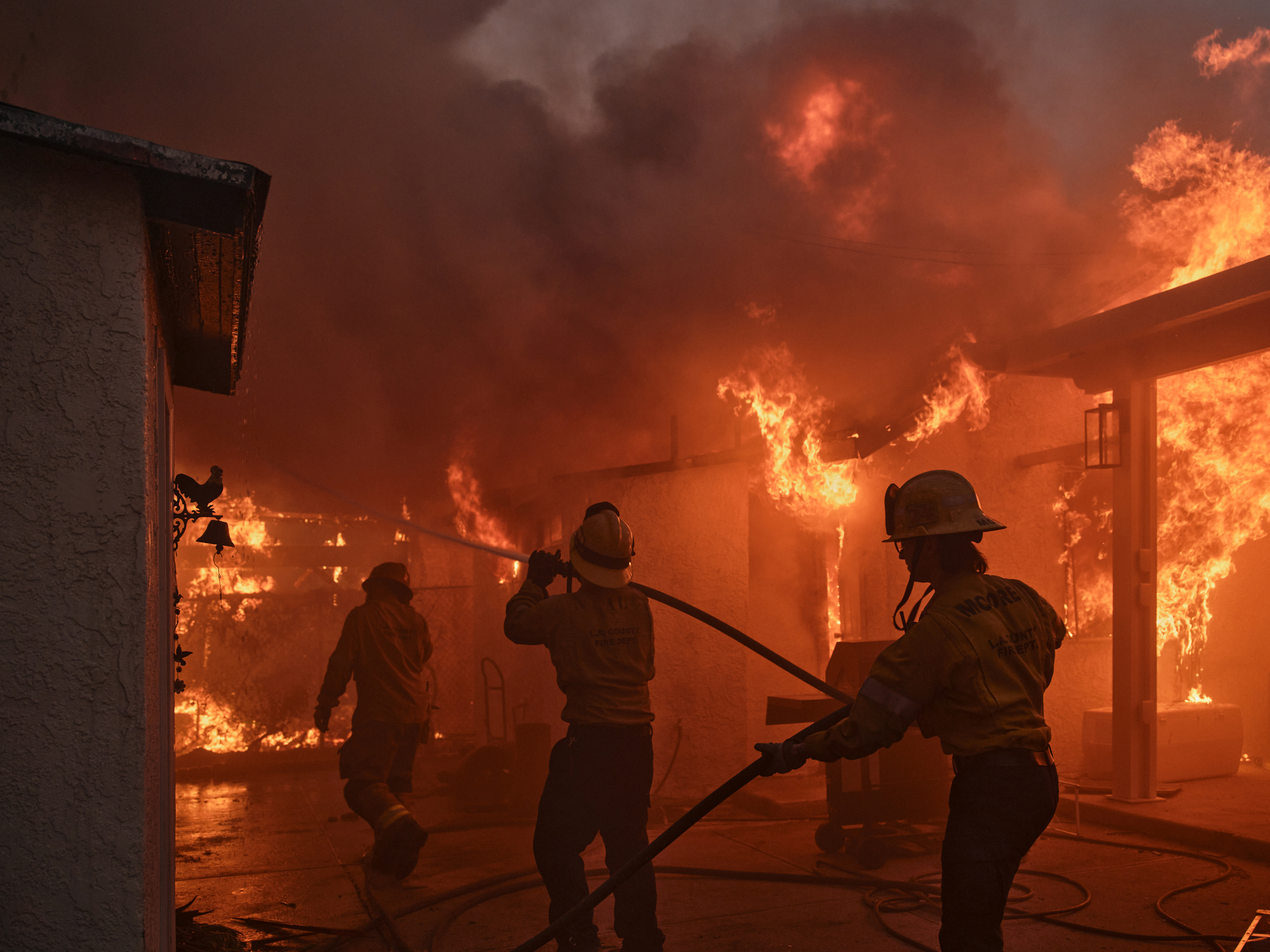 Firefighters battle a blaze in a residential neighbourhood during the Eaton fire in Altadena, California on Wednesday. Photo / Philip Cheung, The New York Times
