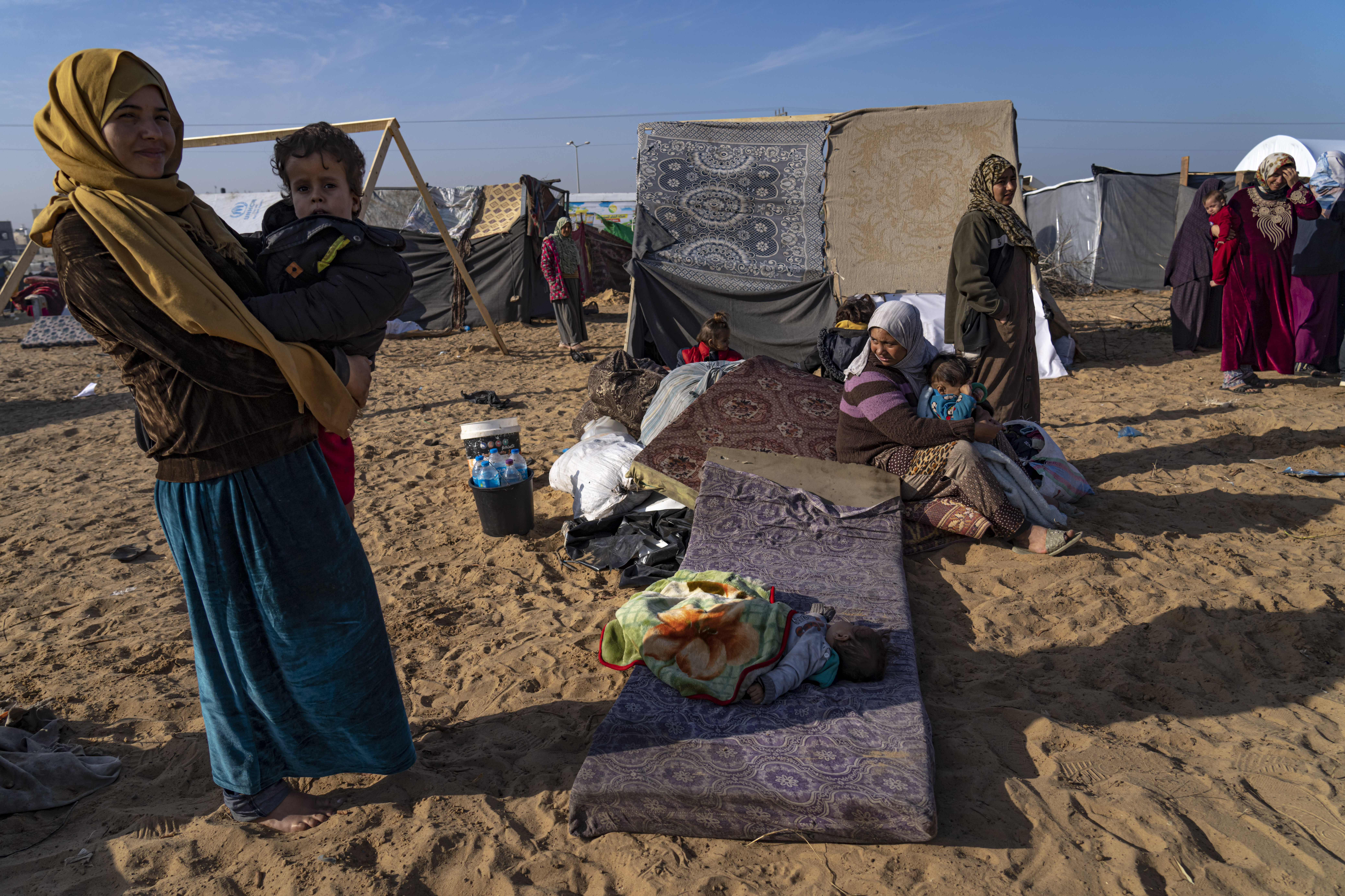 Palestinians displaced by the Israeli bombardment of the Gaza Strip gather at a tent camp, in Rafah, southern Gaza strip. Photo / AP
