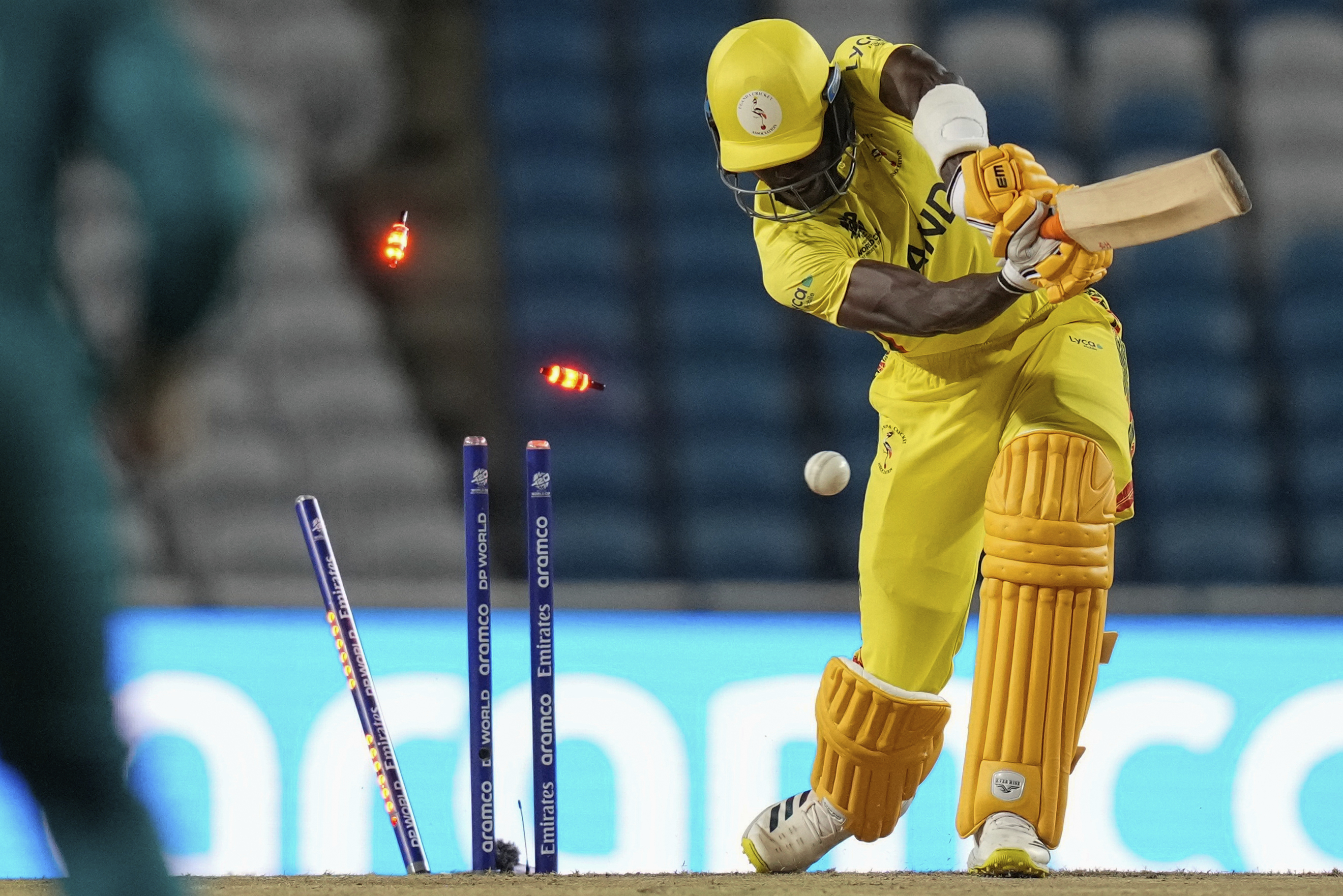 Uganda's Robinson Obuya is clean-bowled by Trent Boult. Photo / AP