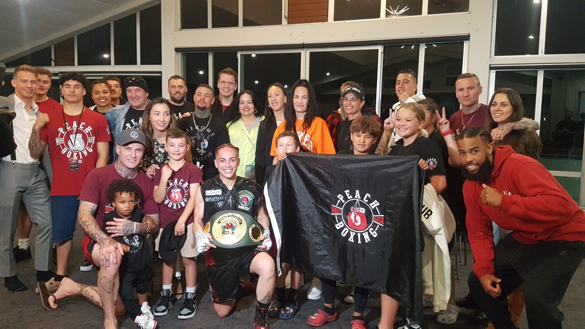 Kaitāia’s Mea Motu celebrates retaining her IBO super-bantamweight world title with family, friends and supporters after the Wahine Toa II fight night at McKay Stadium, Whangārei, including stablemate Jerome Pampellone (right).