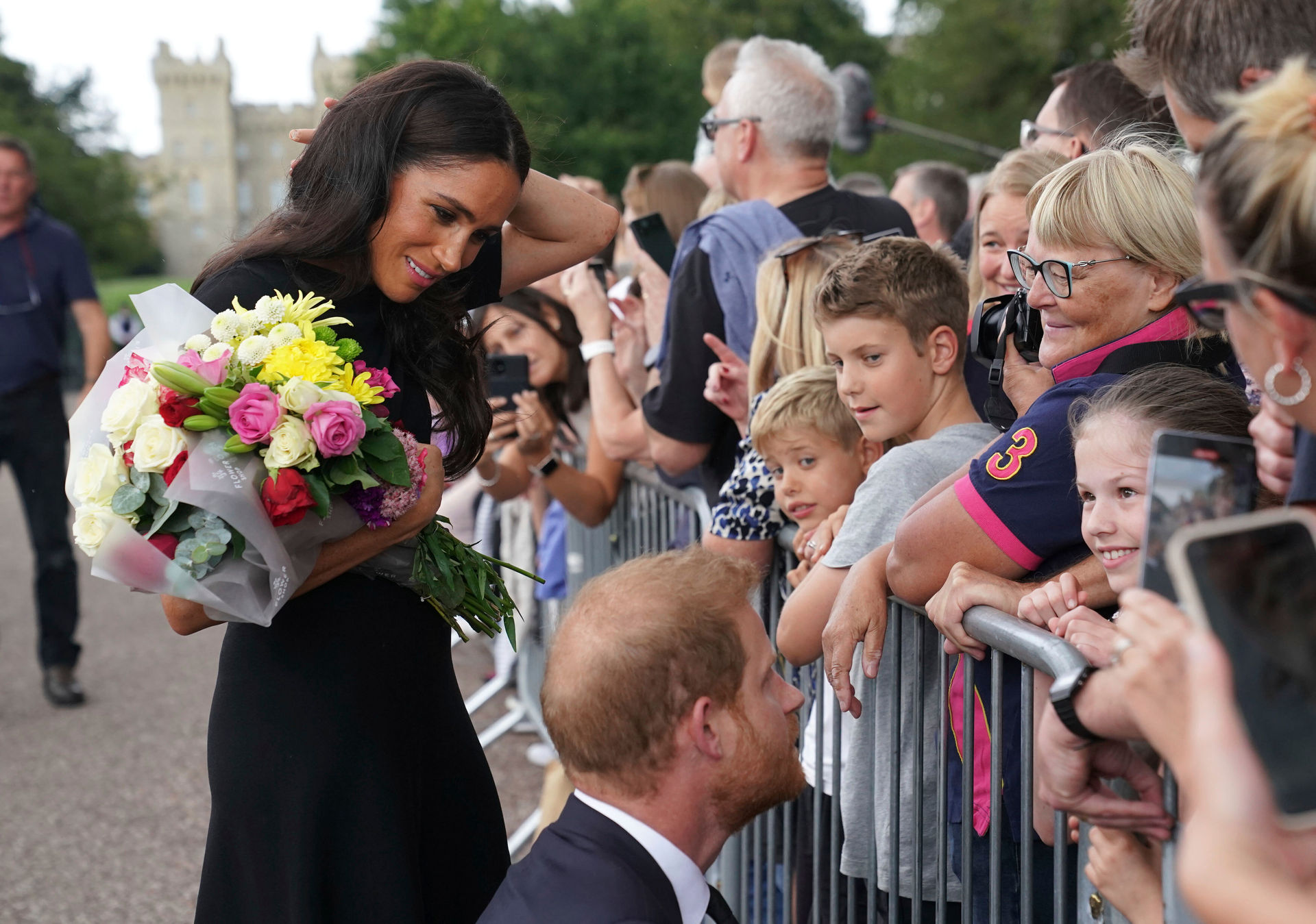 Meghan, Duchess of Sussex and Prince Harry meet members of the public on a walkabout at Windsor Castle, following the death of Queen Elizabeth II. Photo / AP