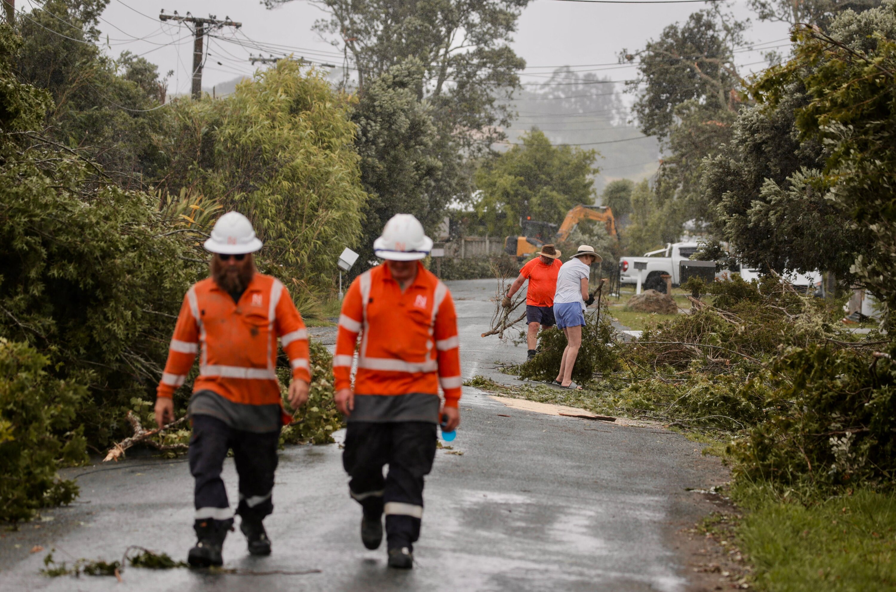 Residents cleaning up after a tornado swept through Mangawhai early yesterday morning. Photo / Alex Burton