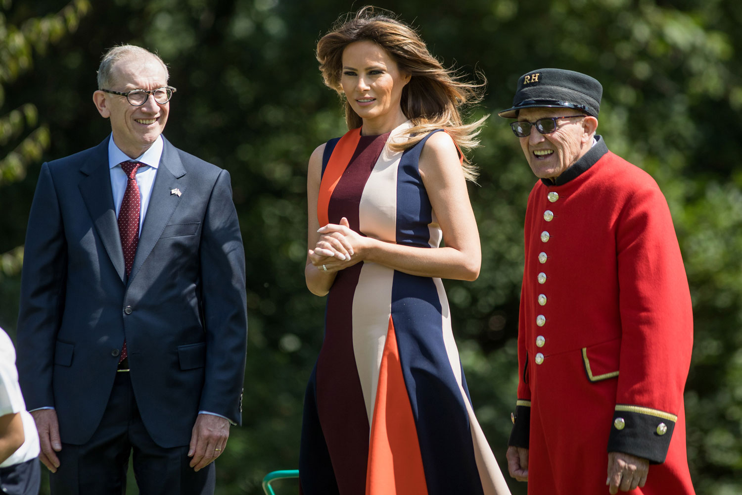 First lady Melania Trump watches lawn bowls while speaking to a military pensioner, right, and Philip May, husband of U.K. Prime Minister Theresa May, during a visit to The Royal Hospital Chelsea in London on Friday. Photo / Jason Alden, Bloomberg