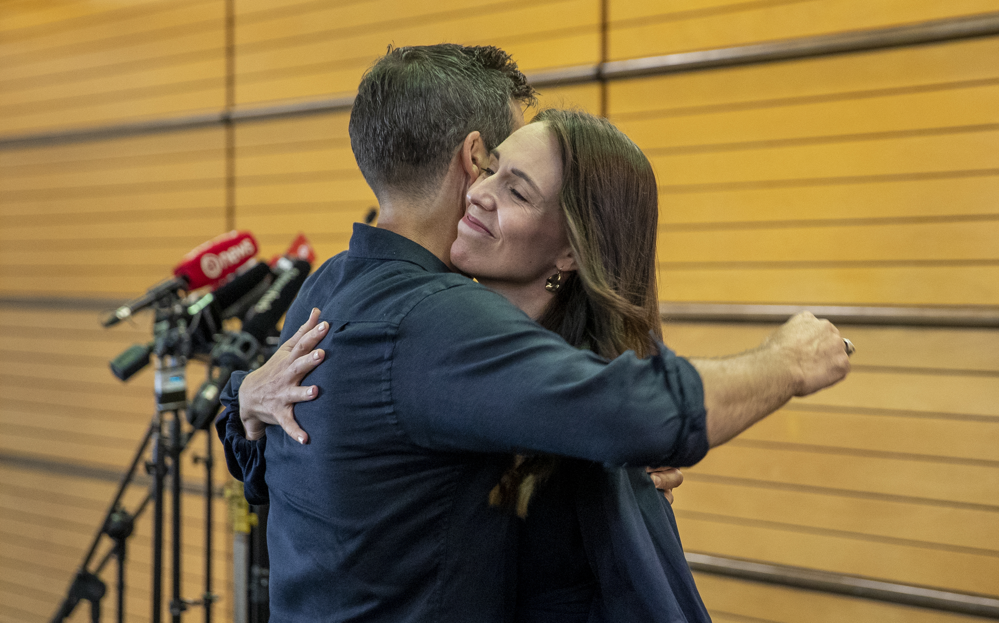 Jacinda Ardern embraces partner Clarke Gayford after announcing her resignation. Photo / Mark Mitchell
