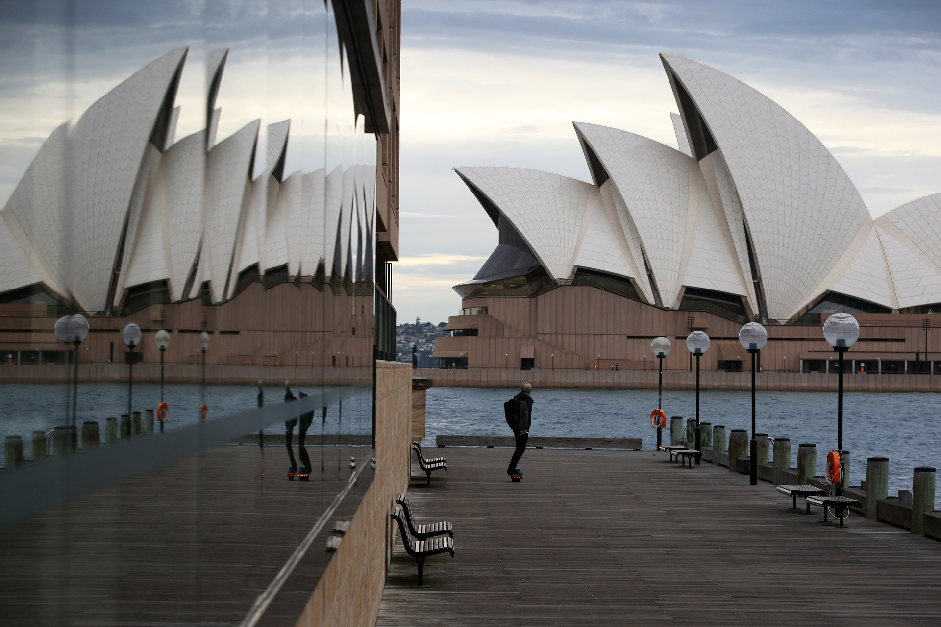 A pedestrian makes their way along Sydney Harbour boardwalk in the CBD during the city's latest Covid-19 outbreak. Photo / Getty Images