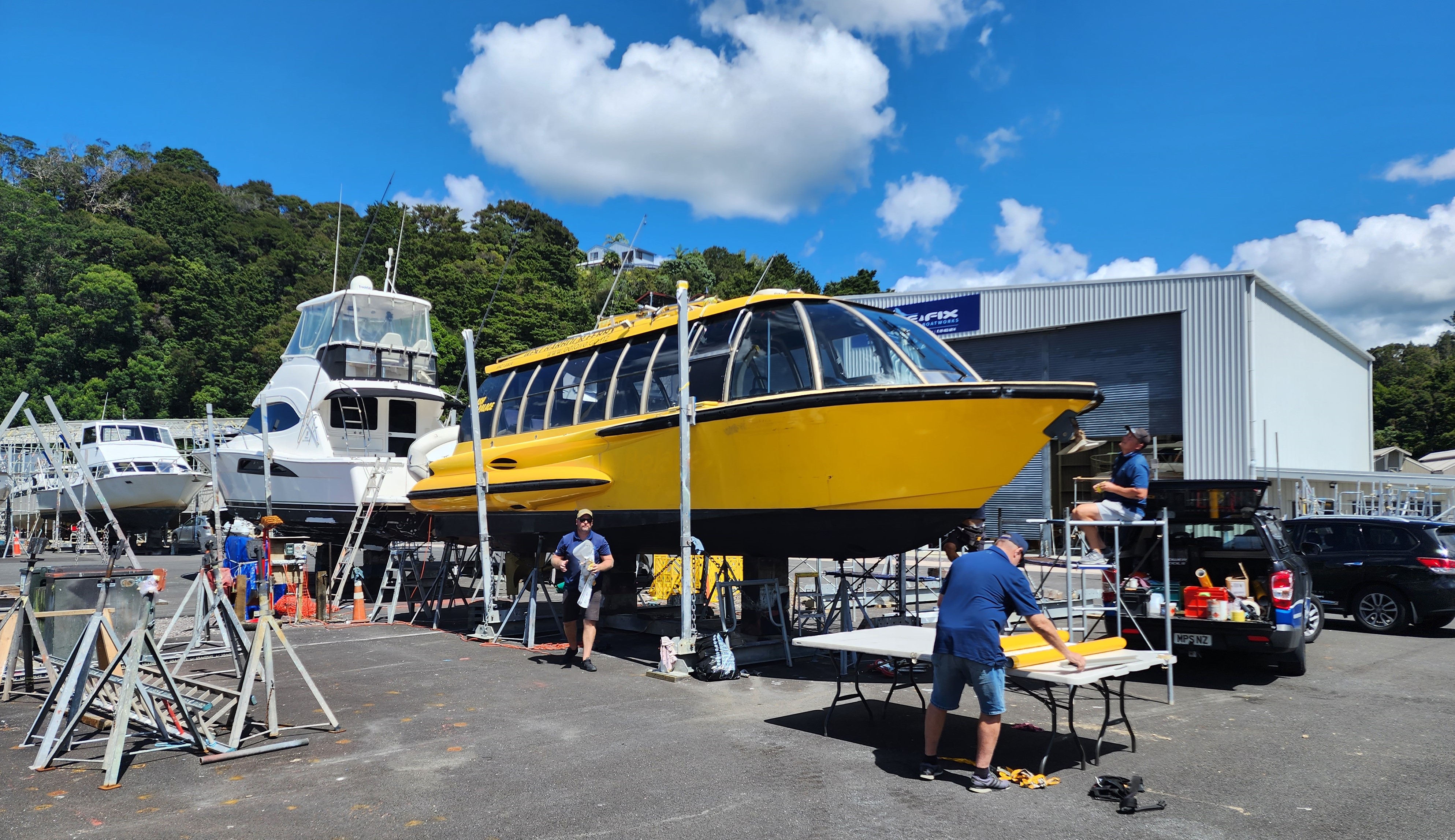 One of the two new Russell ferries gets a yellow wrap at Bay of Islands Boatyard in Ōpua. Photo / Greg Philpott