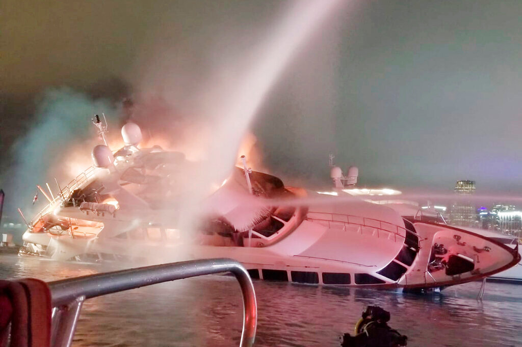 A yacht belonging to singer Marc Anthony in flames at a dock in Miami. Photo / AP