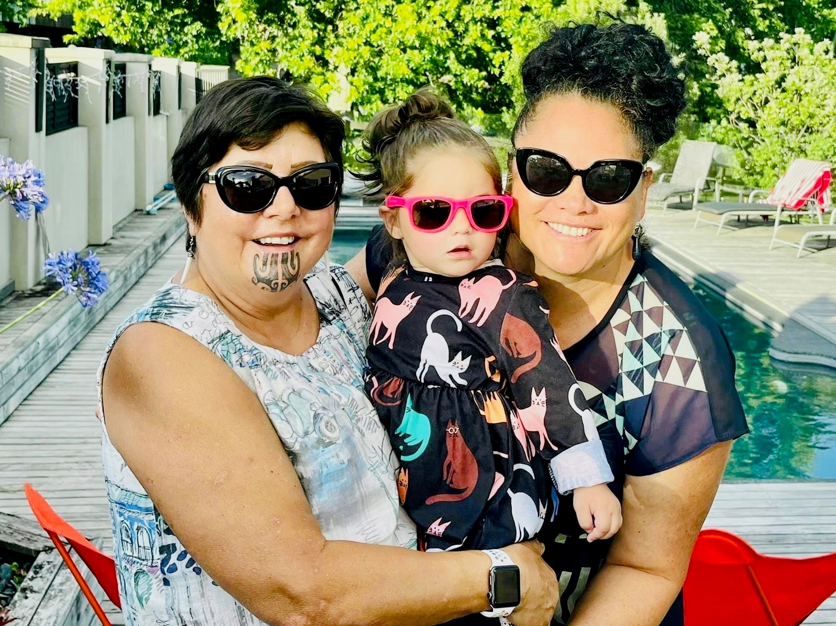 Louisa Wall with wife Prue Kapua, left, and niece Snowy-Rose Te Ruinga Te Rina, by the pool at home. Photo / Supplied