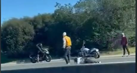 A man is seen injured on the Southern Motorway in a still photo from a video today. Photo / Supplied