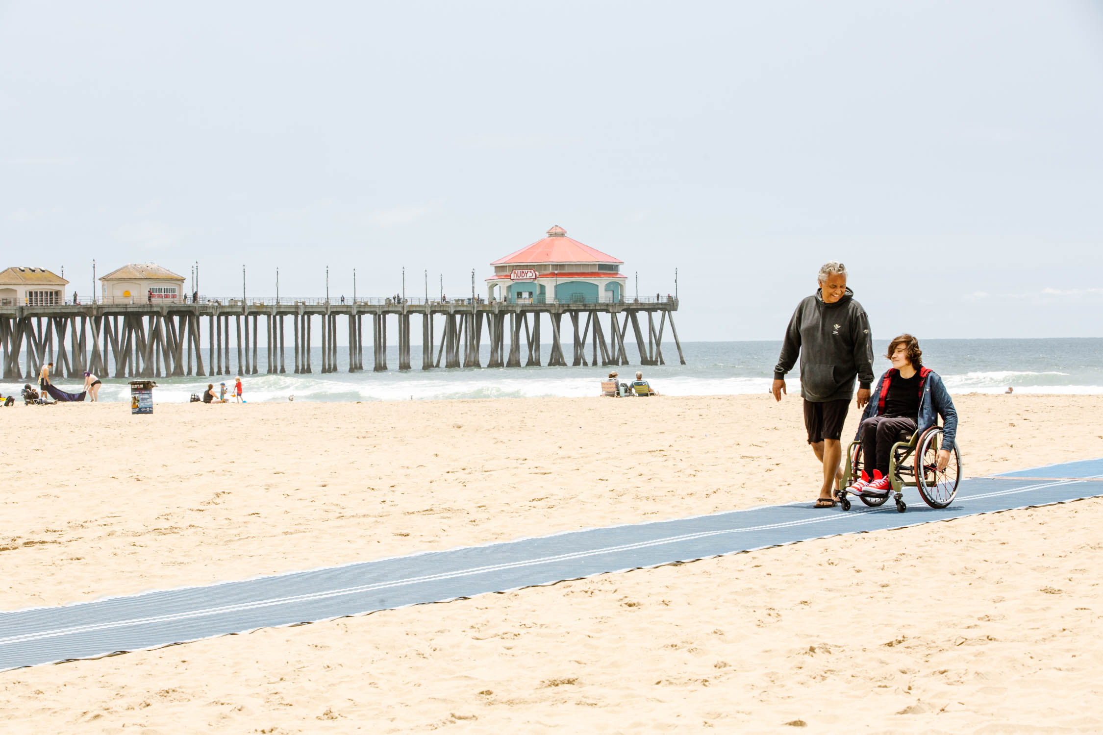 Huntington City Beach has access ramps, and beach wheelchairs available. Photo / Supplied