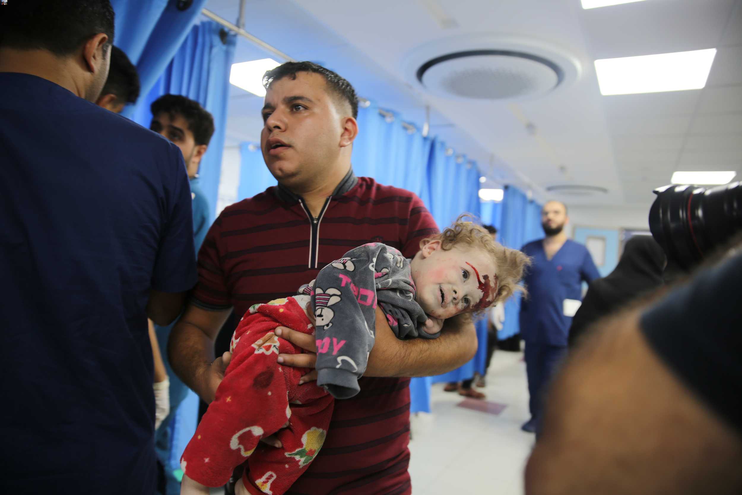 A Palestinian child wounded in Israel strikes is brought to Shifa Hospital in Gaza City on October 11. Photo / AP