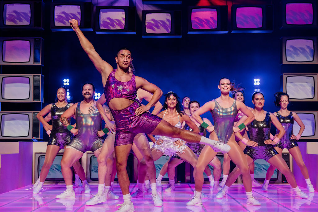 Haka queen Tāwhai Pātai (Kruz Tangira) and the cast of Hyperspace preparing for the New Zealand Aerobics Championships. Photo / Andi Crown