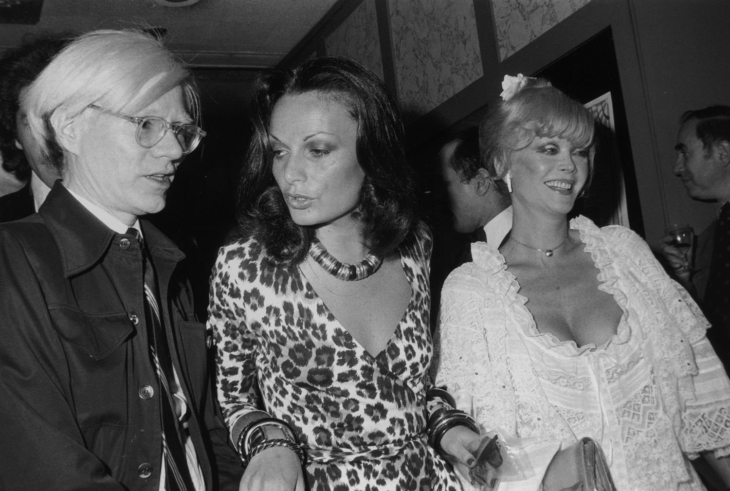 Artist Andy Warhol, fashion designer Diane von Furstenberg, and actor Monique Van Vooren, in 1974. Von Furstenberg is wearing one of her own designs, a leopard print wrap dress.  Photo / Getty Images