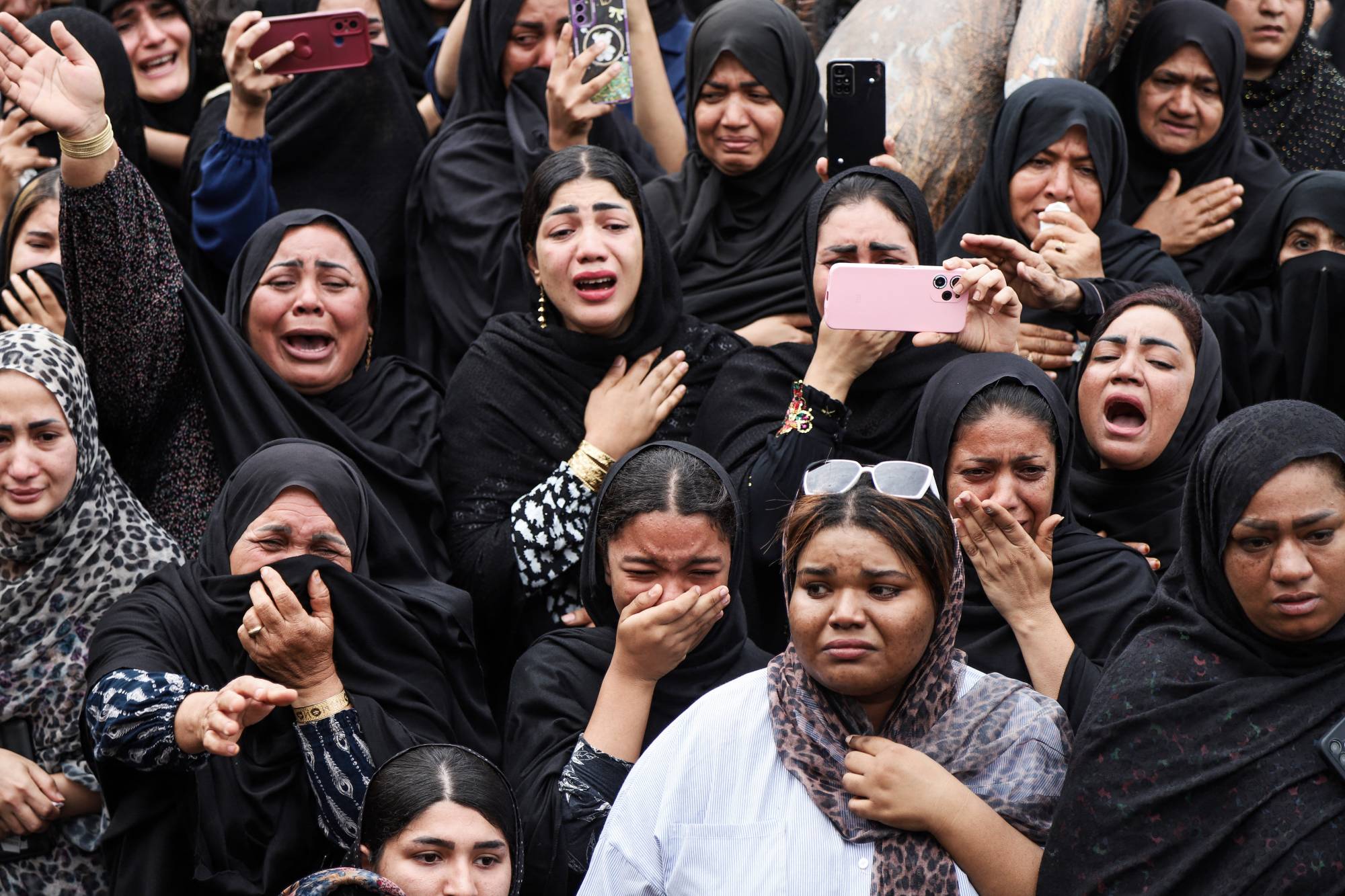 Mourners cry during the funeral of children killed in a reported strike on a primary school in Iran's Hormozgan province. Photo / Amirhossein Khorgooei, ISNA, AFP