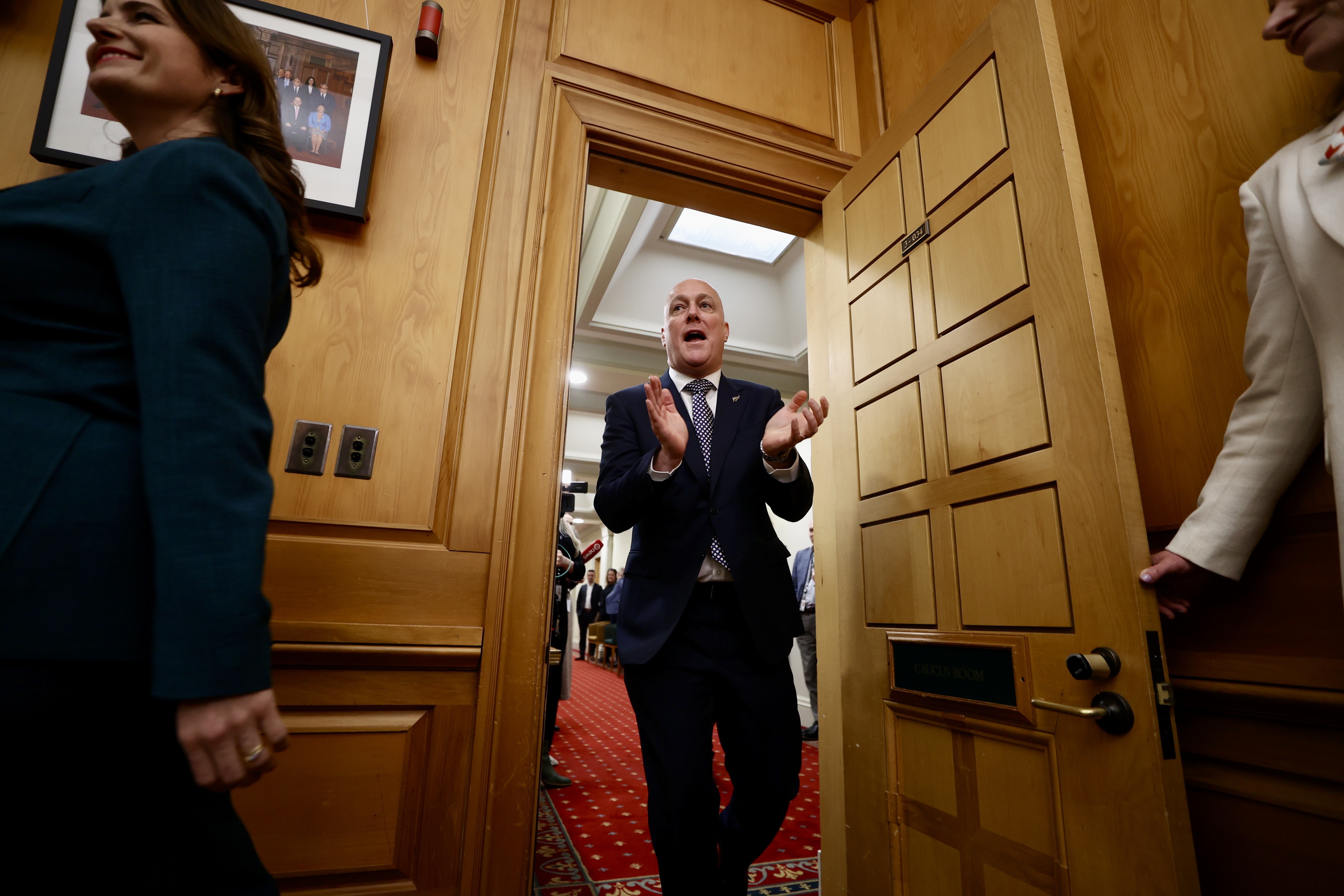 Prime Minister designate Christopher Luxon greets his caucus colleagues after speaking to media at Parliament. Photo / George Heard