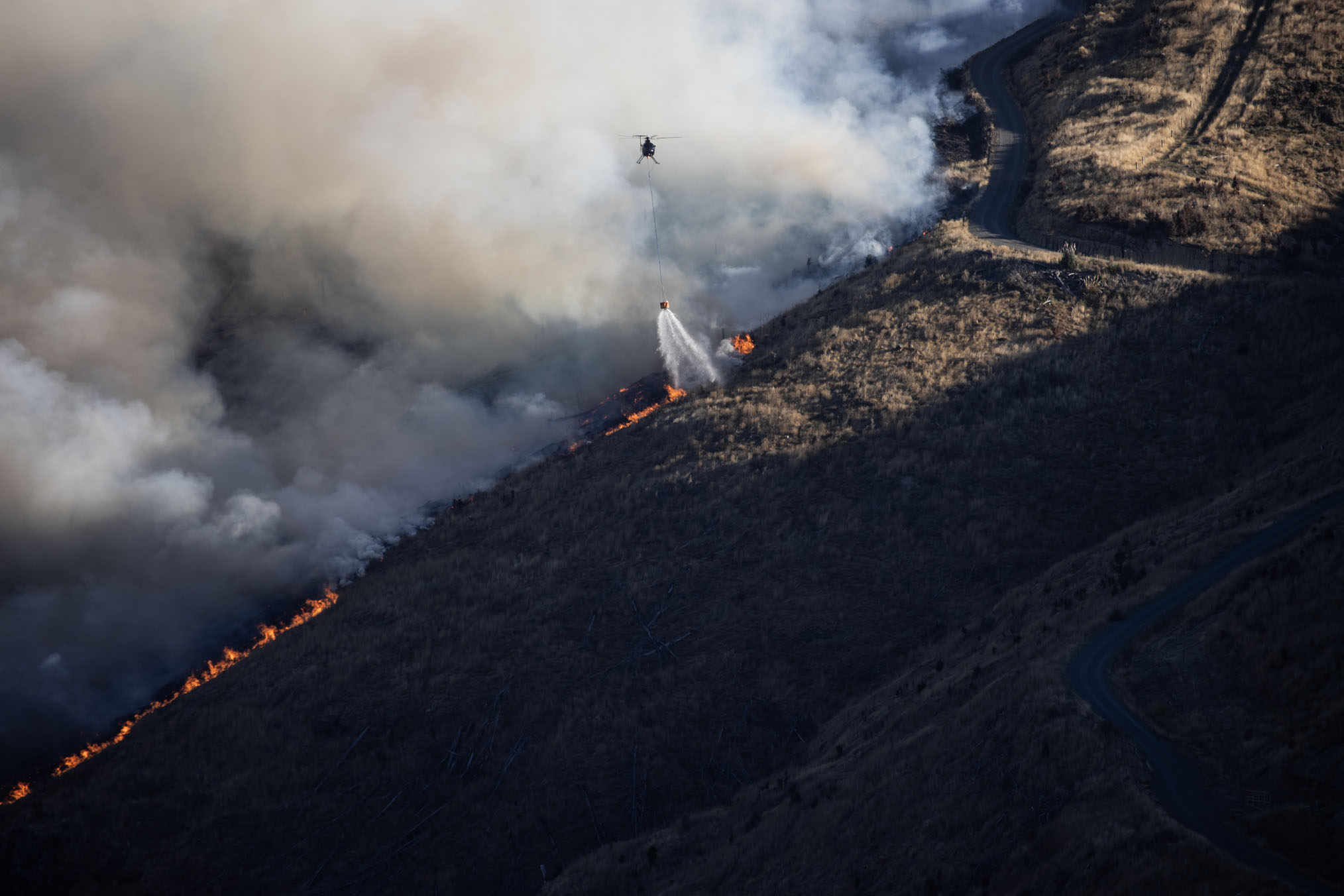 Firefighters battling the fire on Christchurch's Port Hills on Wednesday afternoon. Photo / George Heard