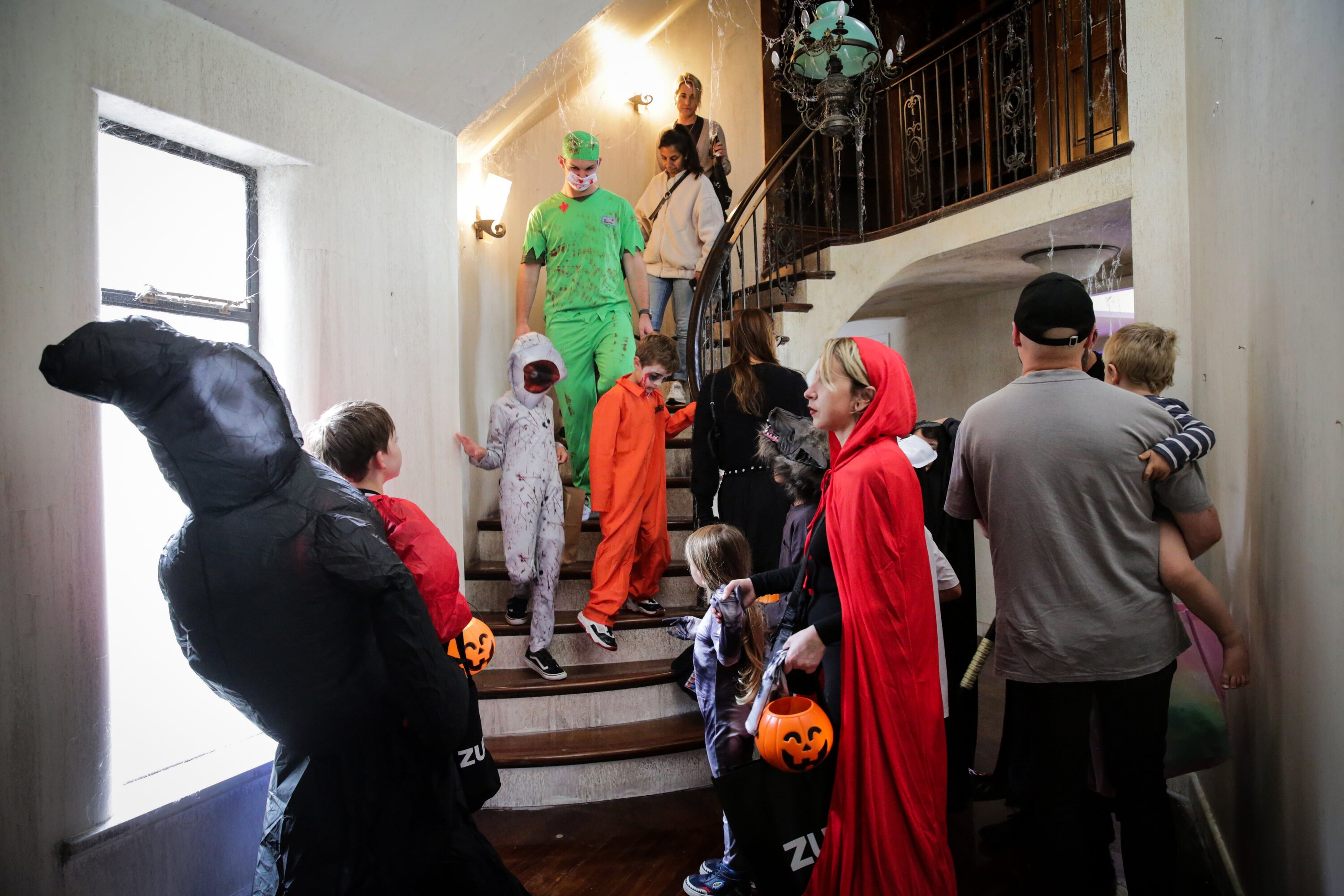 Children dressed in Halloween costumes queue at the Zuru founder's Mowbray house in Herne Bay, Auckland for Trick or Treat Zuru toys and lollies
New Zealand Herald photograph by Sylvie Whinrary 31 October 2024