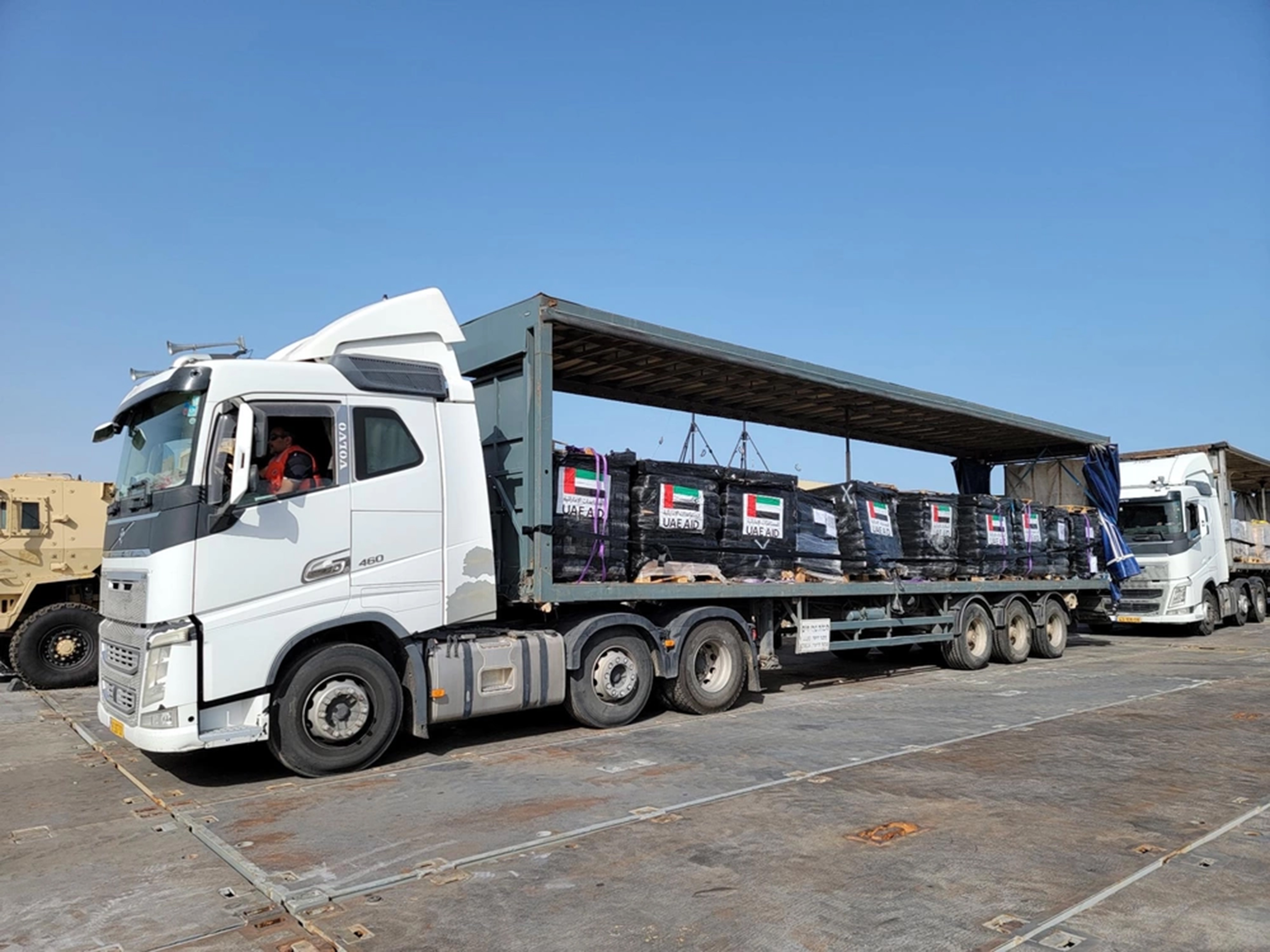 Trucks loaded with humanitarian aid from the United Arab Emirates and the United States Agency for International Development cross the Trident Pier before entering the beach in Gaza. Photo / US Navy via AP