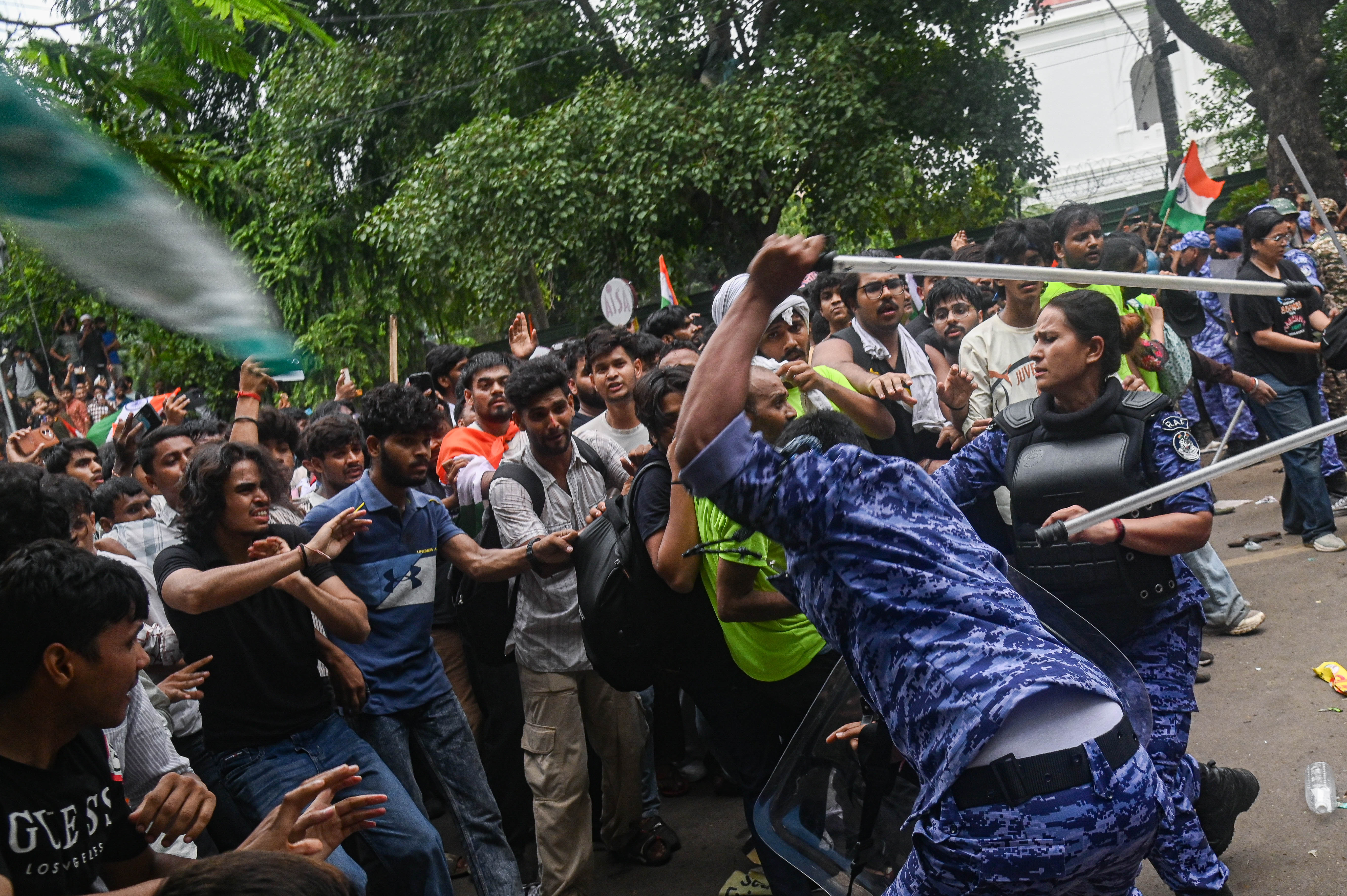 Police officers use batons to disperse protestors during a march by the Cockroach Janta Party. Photo / Getty Images