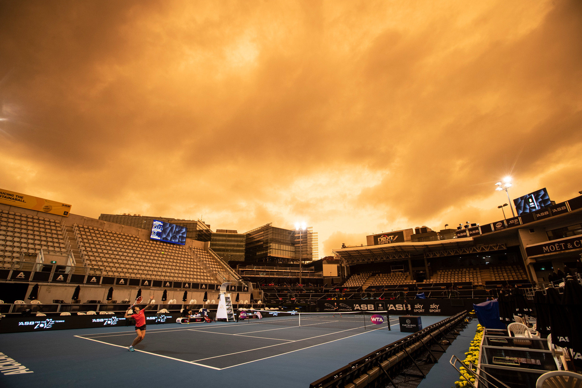Players practised at Auckland's ASB Tennis Centre on under an orange sky on January 5, 2020. Photo / Jason Oxenham