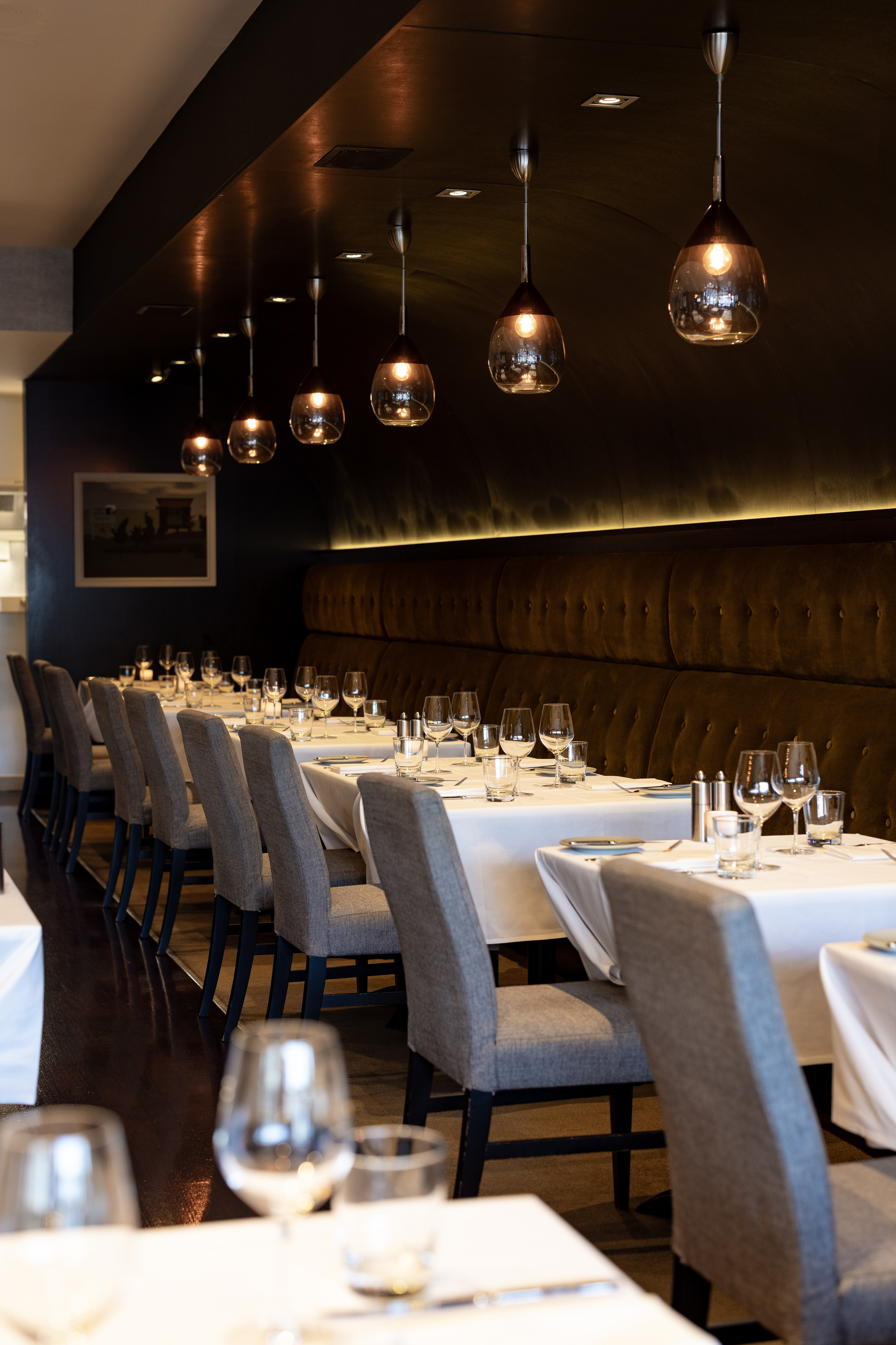 The dining room is dressed with pristine white tablecloths. Photo / Babiche Martens