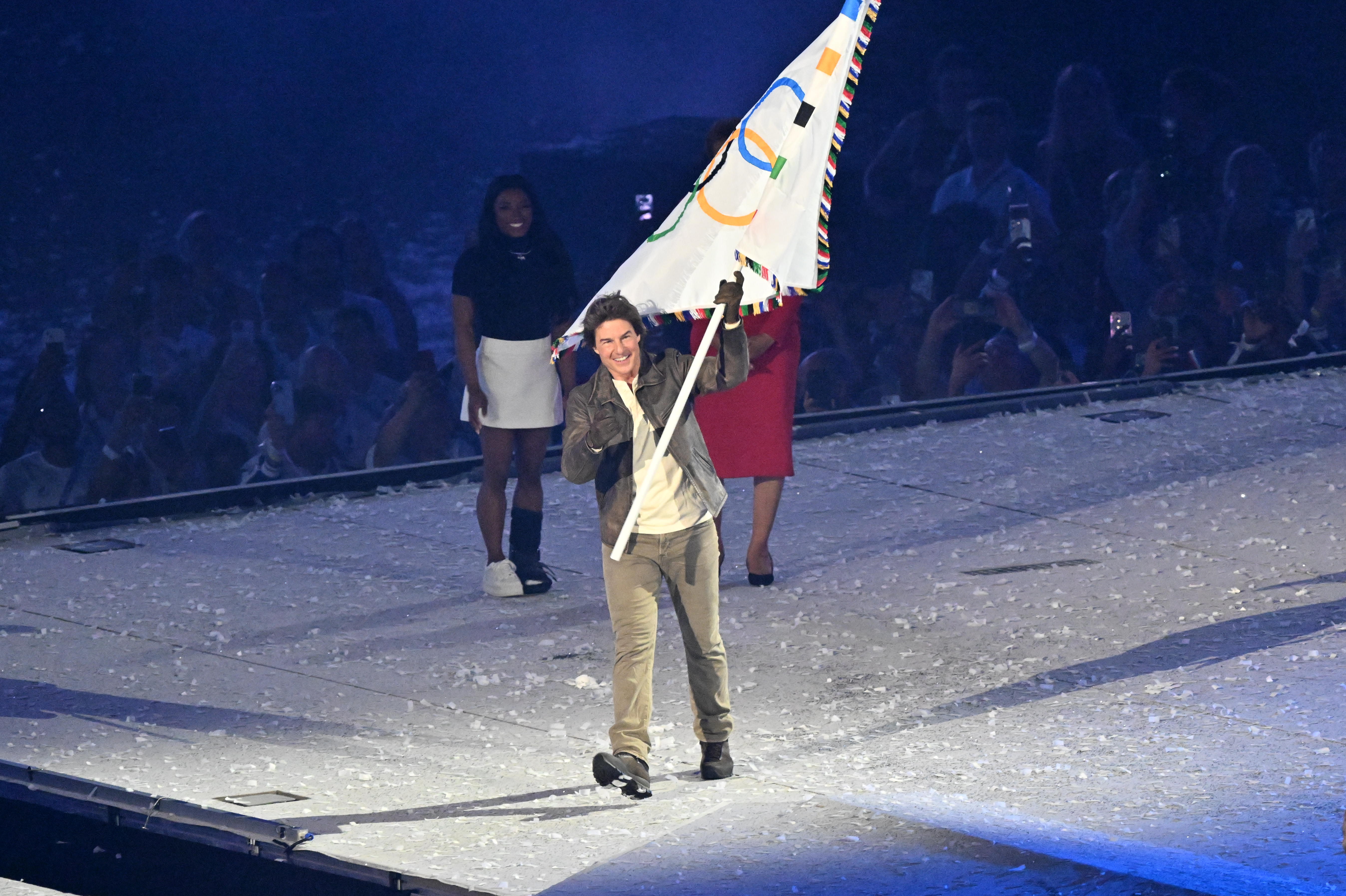 Actor Tom Cruise waves the Olympic flag during the closing ceremony of the Paris 2024 Olympic Games at the Stade de France. Photo / Getty Images