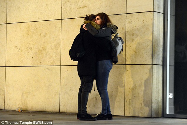Survivors hug outside the Manchester Arena after a suspected terror attack. Photo / Thomas Temple