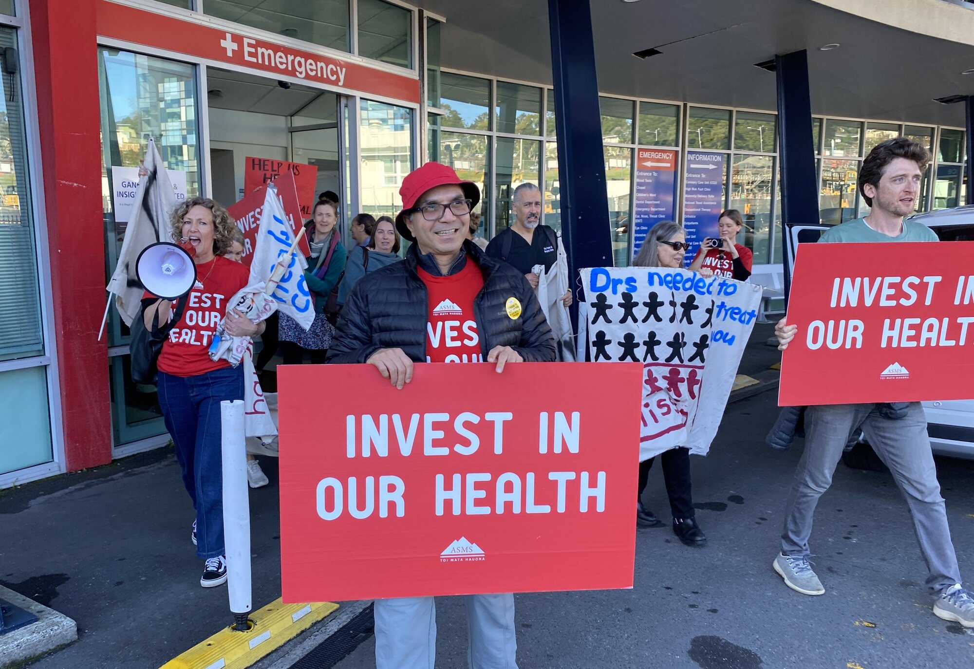 Senior doctors with the the Association of Salaried Medical Specialists symbolically walk out the doors of Whangārei Hospital after going on strike at 10am on Wednesday. Photo / Denise Piper