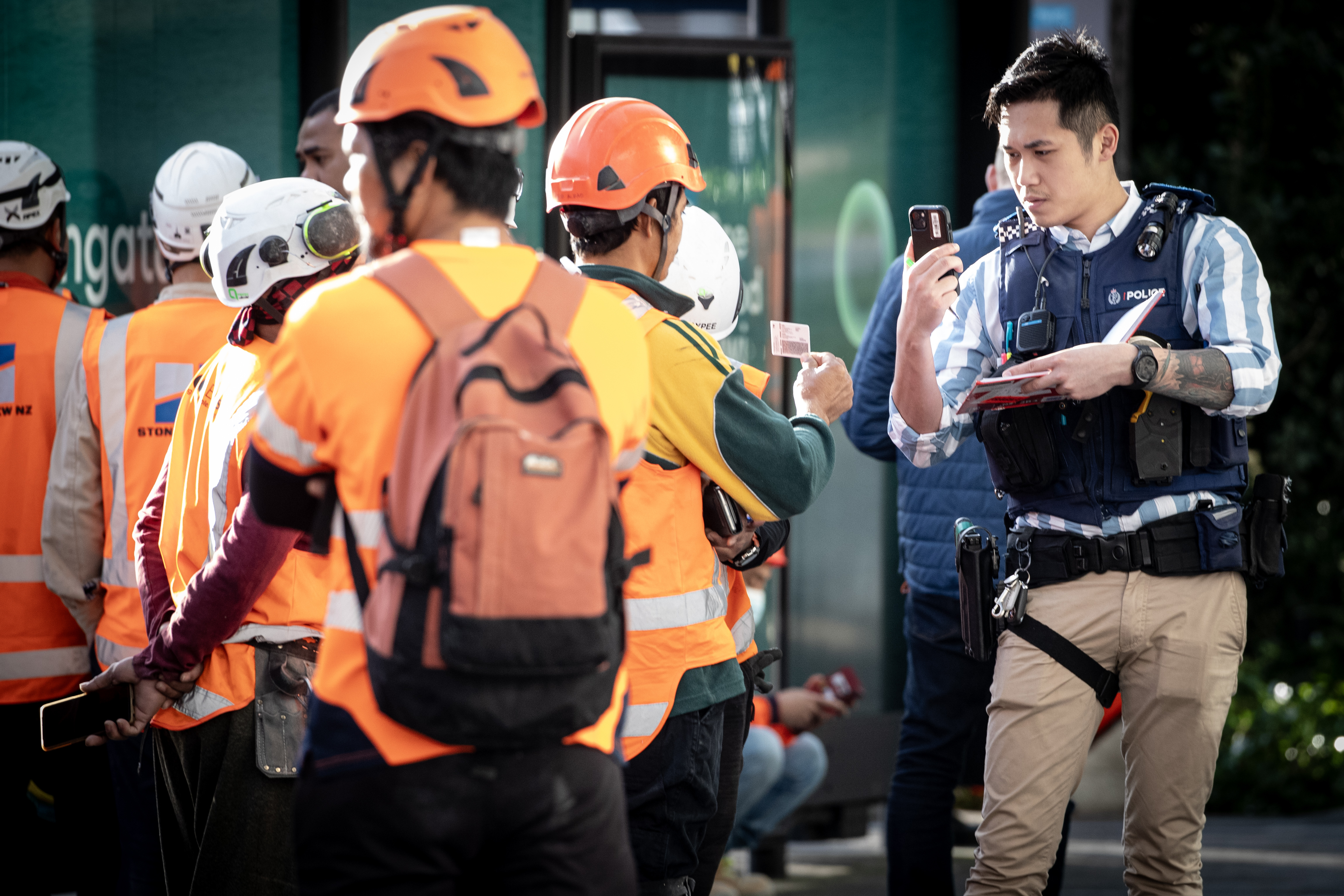 Armed police and construction workers in downtown Auckland during the shooting in July. Photo / Jason Oxenham