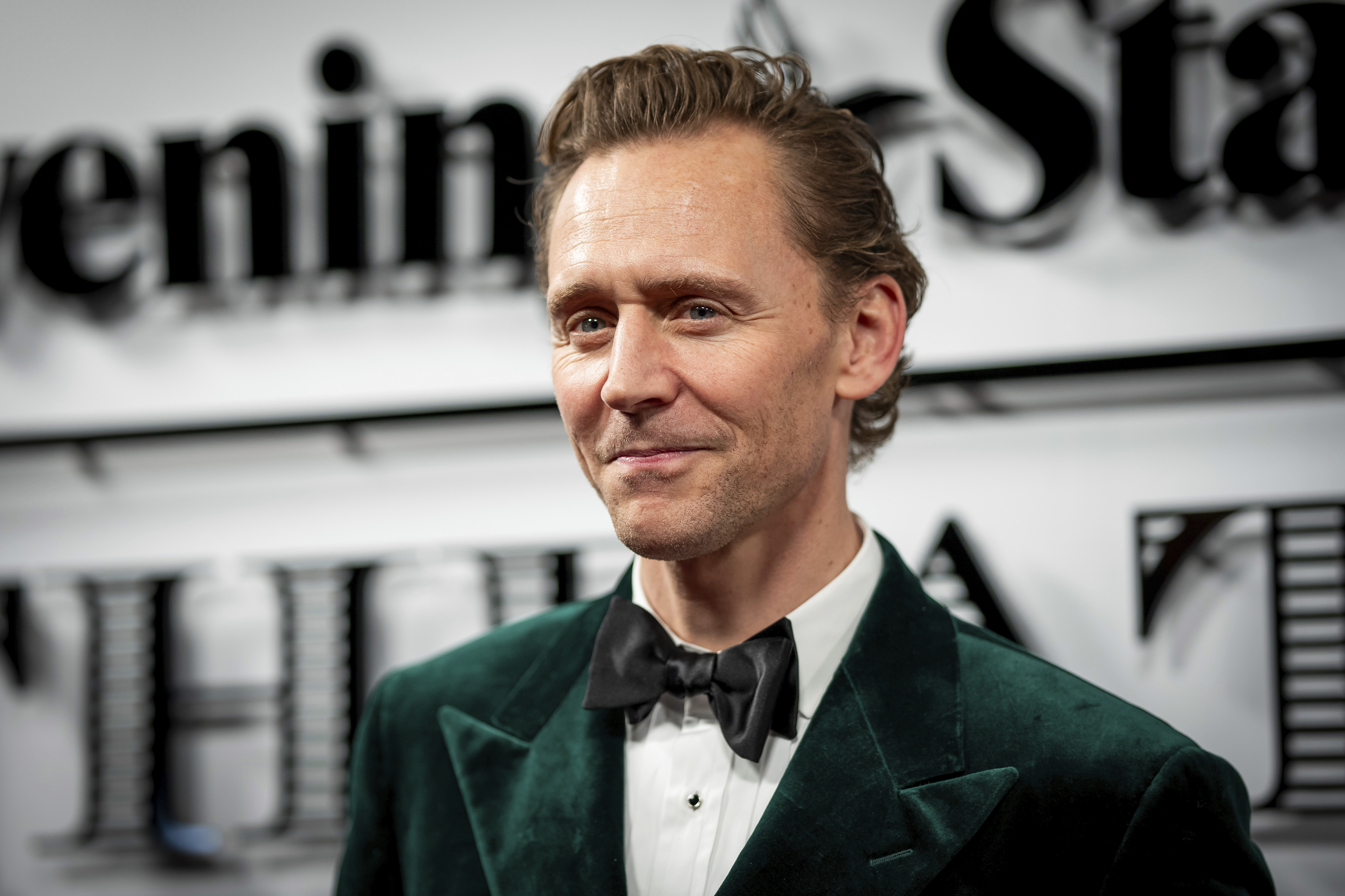 Actor Tom Hiddleston stands in for King Charles at a charity event