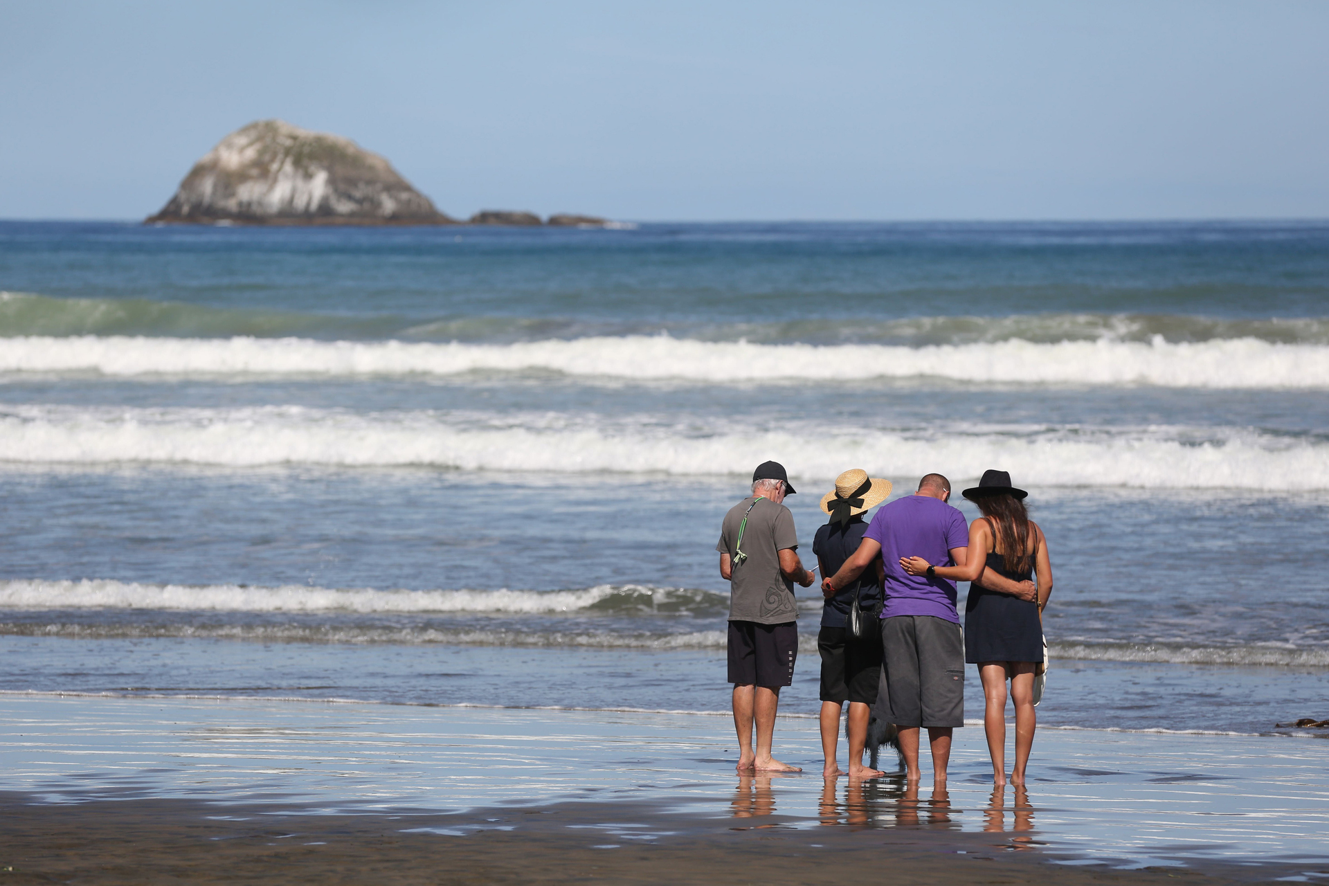 Friends of Sarah-Jane Bayram pay their respects at a Māori blessing ceremony at Muriwai Beach days after she died in a skydiving accident. Photo / Sylvie Whinray