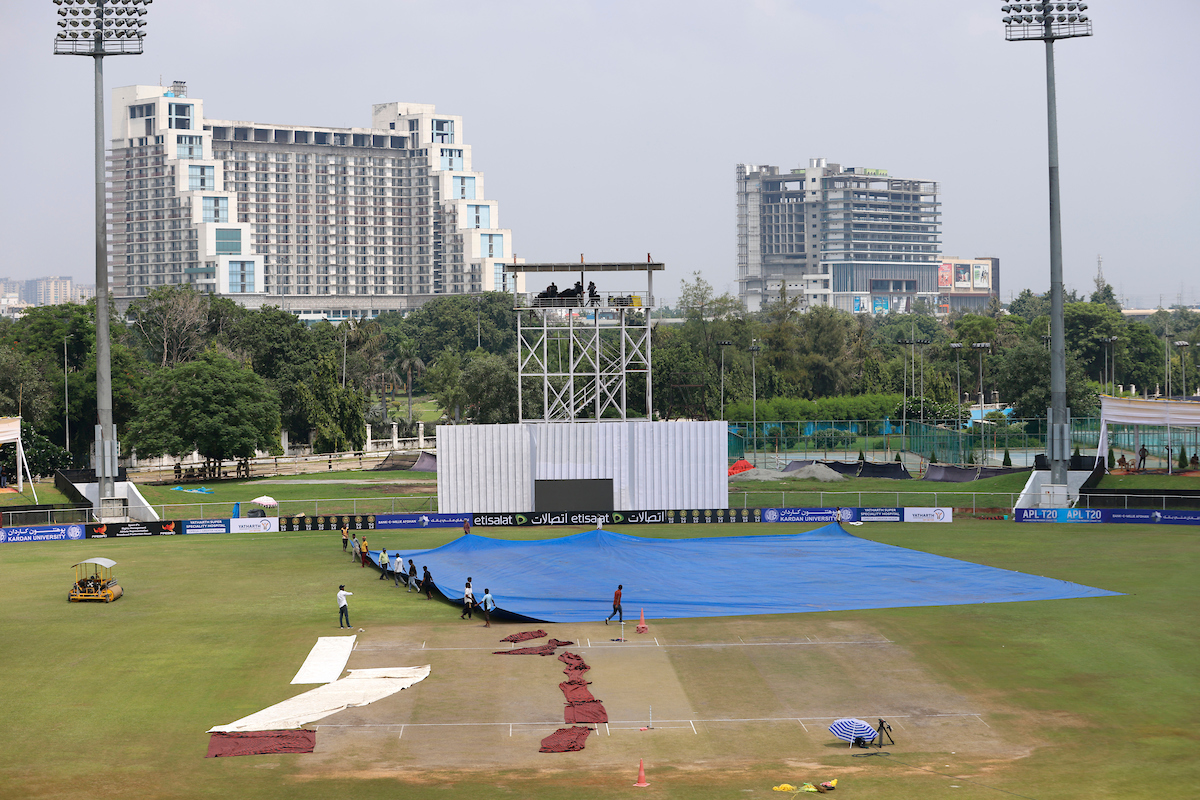 Ground staff prepare to cover the field before the start of the one-off test between the Black Caps and Afghanistan, which was evenutally cancelled without a ball being ball being bowled. Photo / Photosport