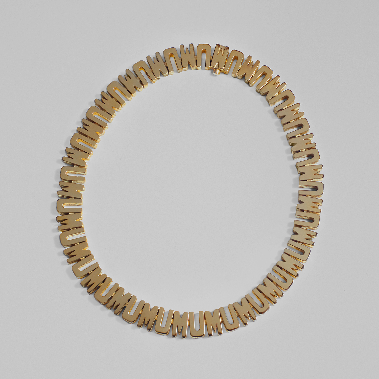 It is the very definition of a statement piece, with the letters ‘M’ and ‘U’ alternated in chunky capitals circling the neck. 