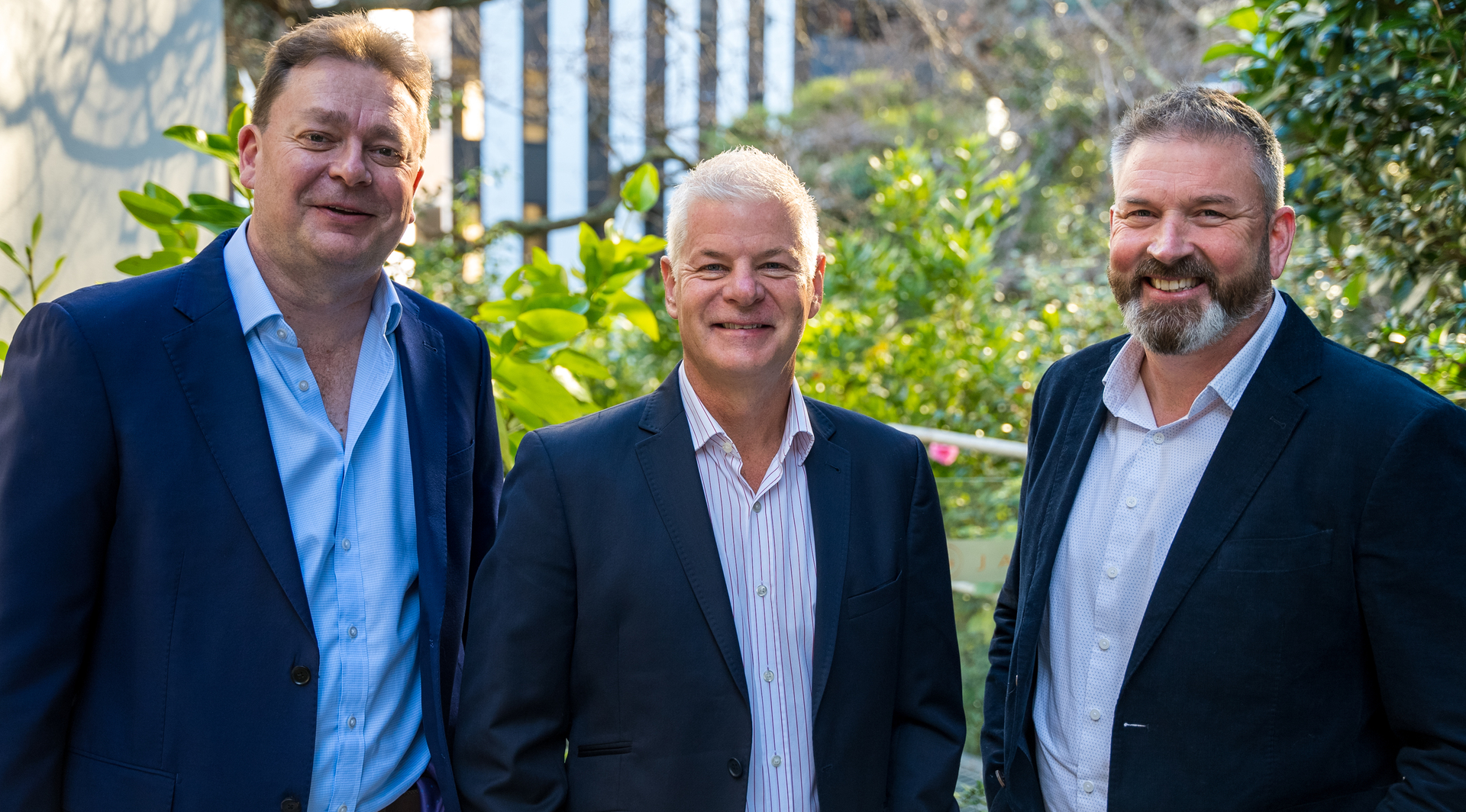 Qual IT's brother-in-law founders Shane Hewson (left) and Jon McPhee (right) with Planit chief executive Mike Weale (centre). Photo / Supplied 