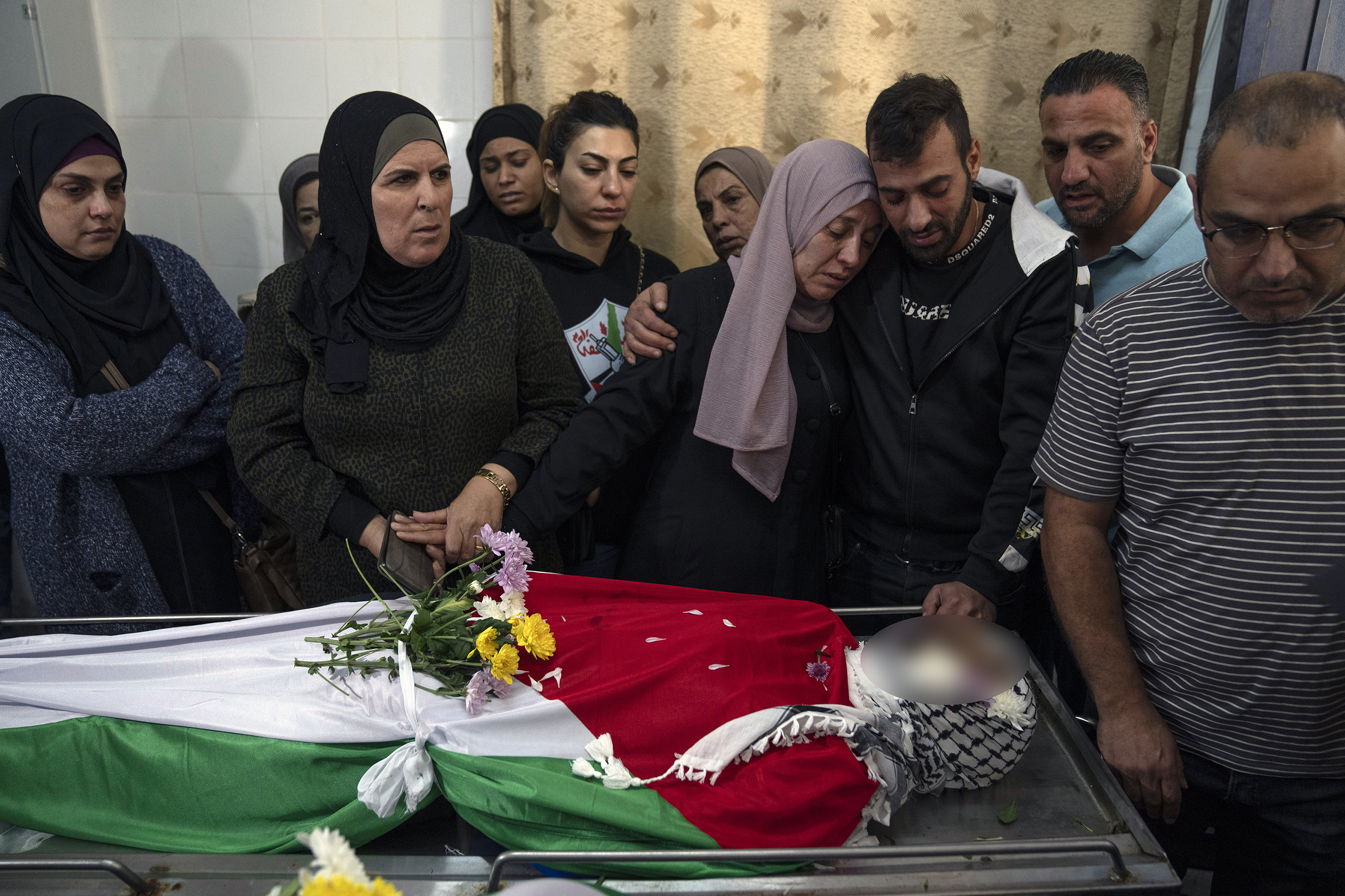 Mourners take the last look at the body of Ibrahim Awad, killed during clashes with Israeli settlers near his home village of Dura al-Qara'. Photo / AP