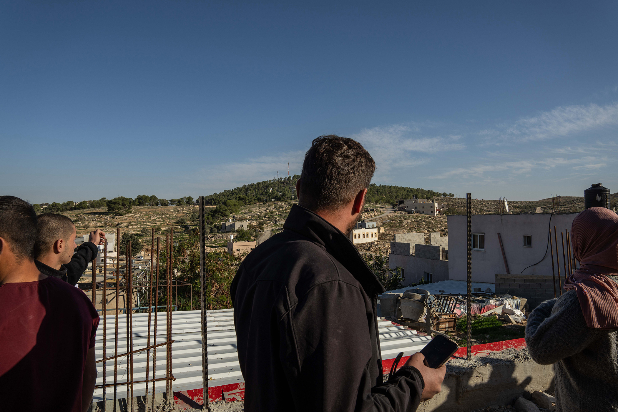 Palestinian villagers watch Israeli settlers and soldiers attack villagers in At-Tuwani on the West Bank. Photo / Samar Hazboun for The New York Times