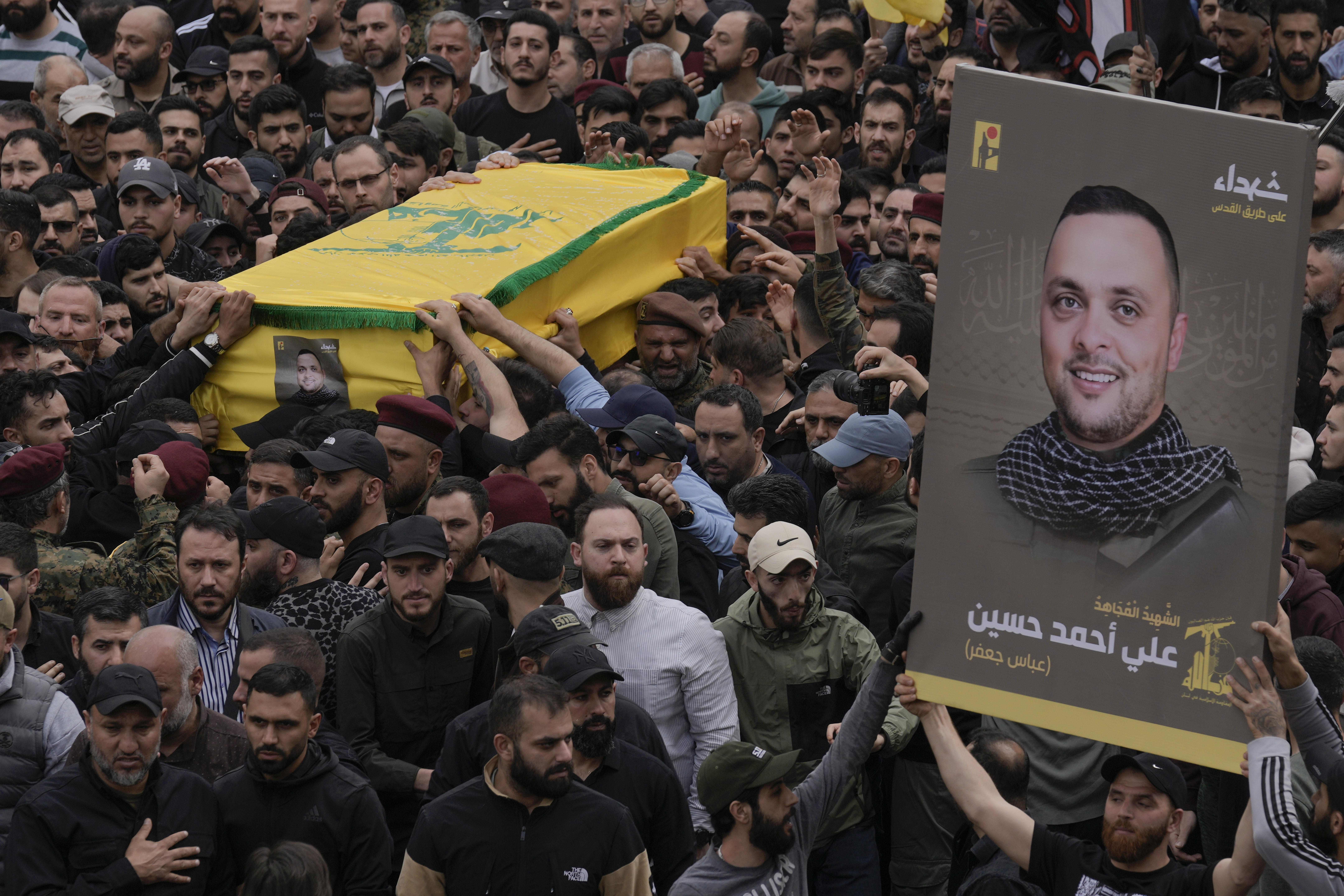 Hezbollah fighters carry the coffin of their comrade, Ali Ahmad Hussein, who was killed by an Israeli strike in south Lebanon, during his funeral procession in the southern Beirut suburb of Dahiyeh, Lebanon. Photo / AP