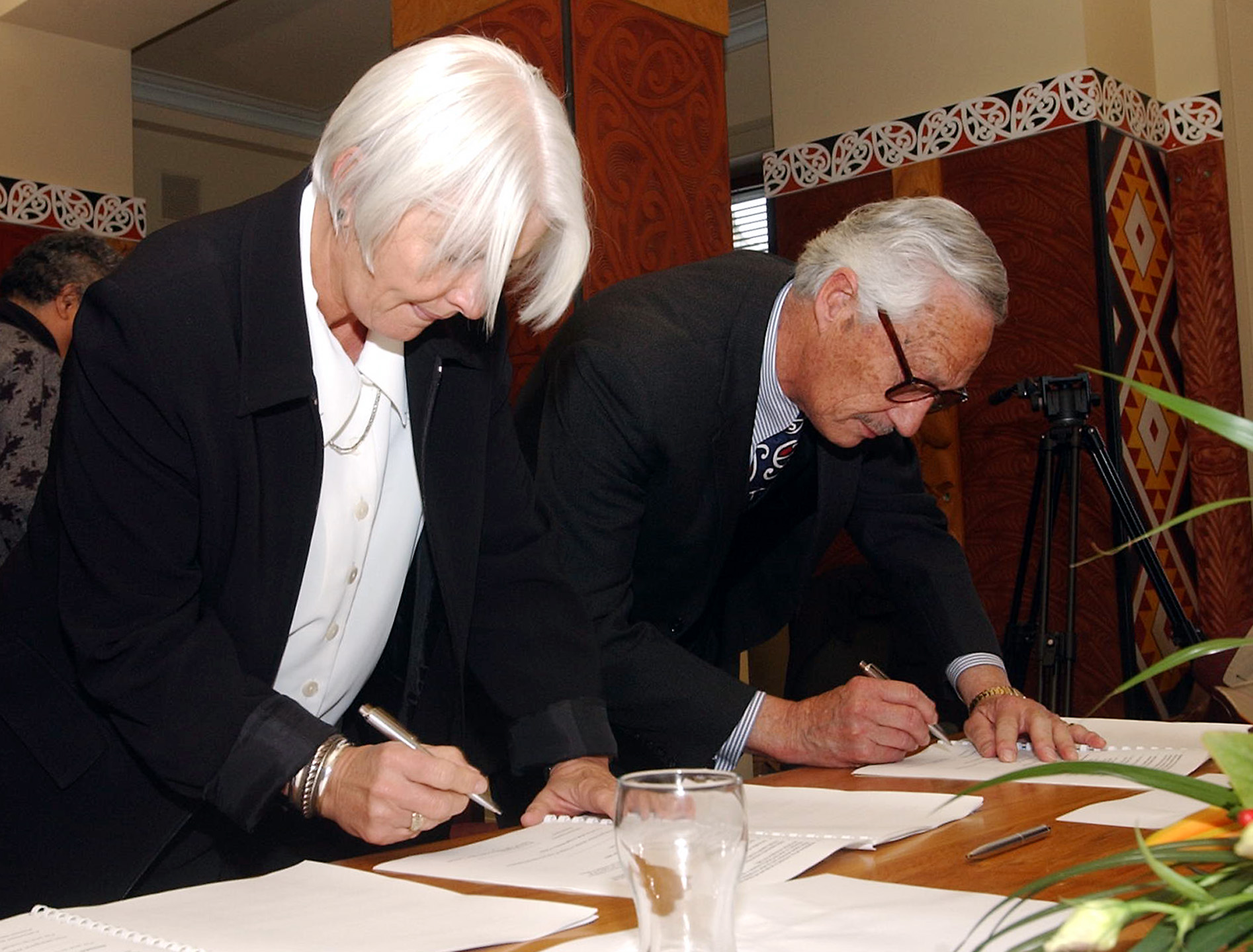 Treaty Negotiations Minister Margaret Wilson (left) and Sir Hugh Kawharu sign the terms of negotiation at the beginning of the Ngāti Whātua Ōrākei Treaty negotiations at Parliament in 2003.